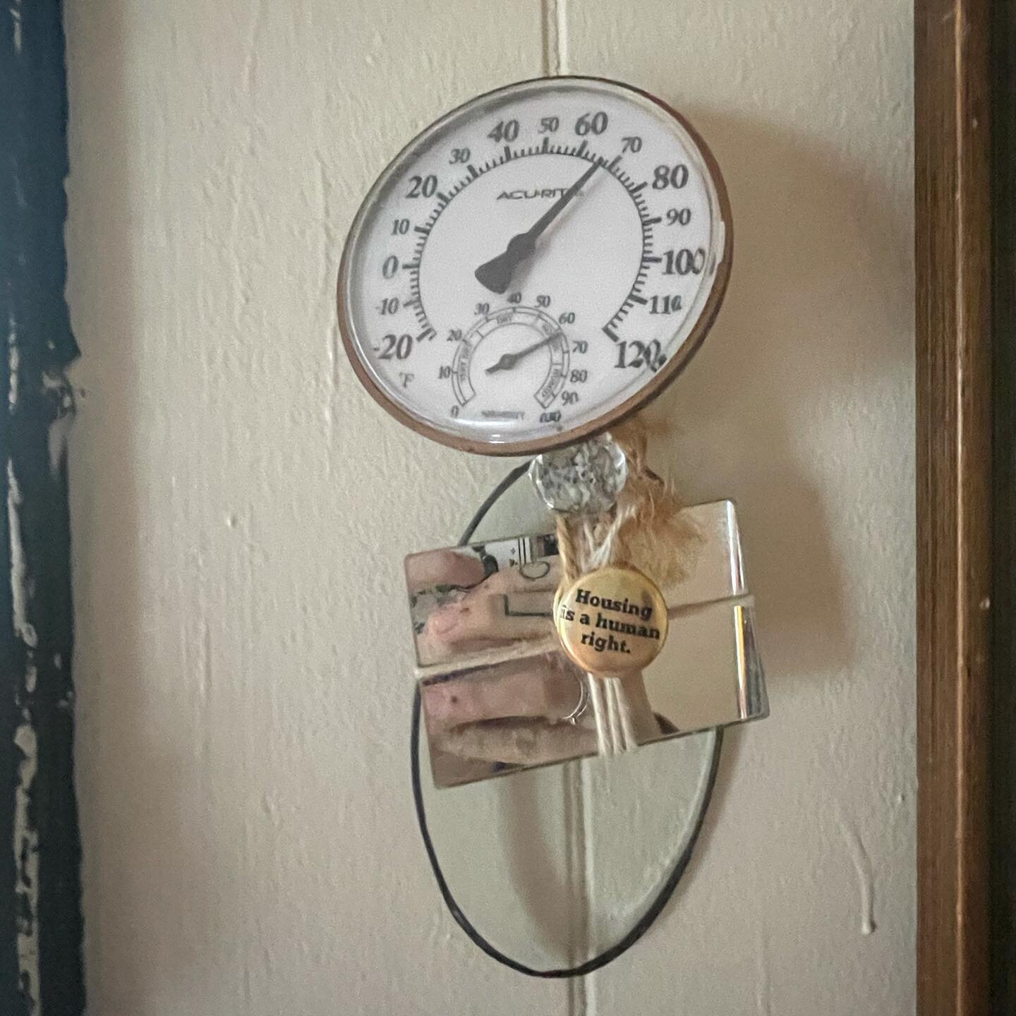 Made from Great Grandmother&rsquo;s alleged coke mirror, twine, protest button, rainbow bead, thermometer, glass panel