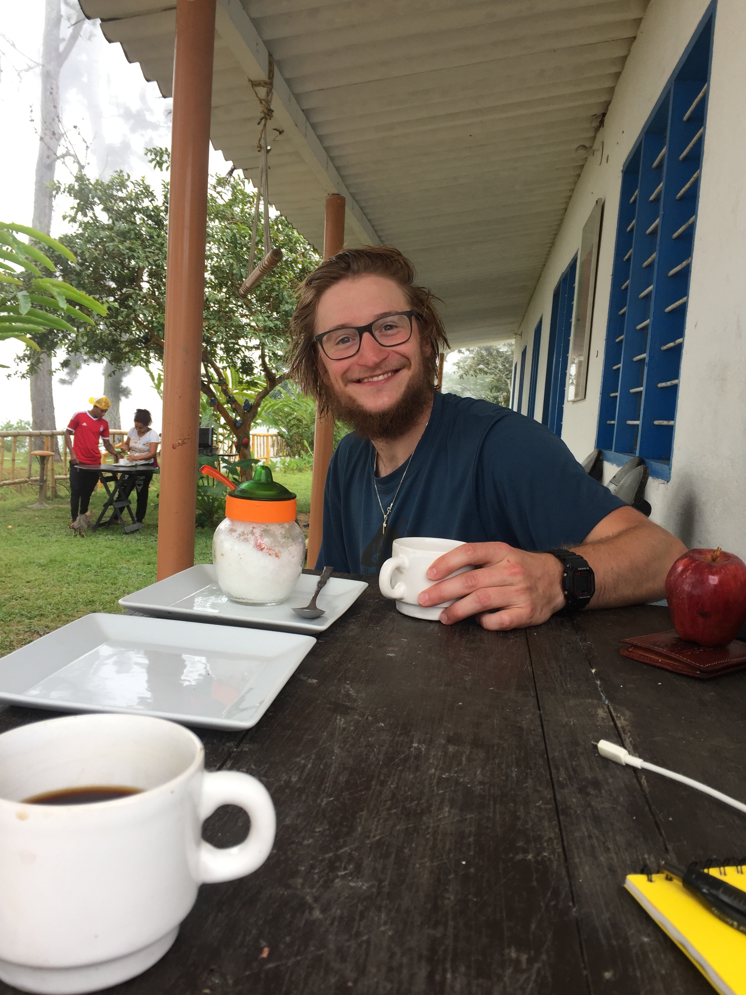   MINCA, COLOMBIA – JULY 26TH, 2017: My friend Bertie and I drink coffee at Hostel Los Pinos at the end of a 5 mile trek into the mountains. He was just one of the many charming people I met in Minca . 