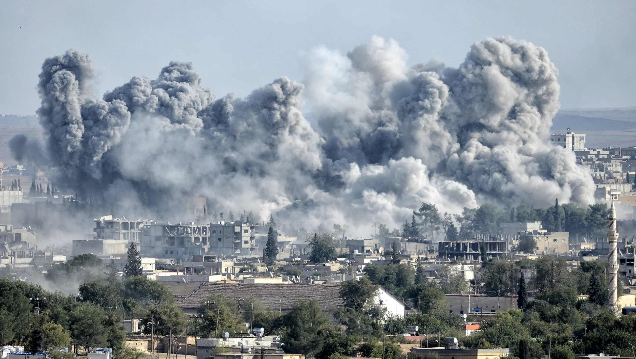 PICTURED: An explosion after an apparent US-led coalition airstrike on Kobane, Syria, as seen from the Turkish side of the border. Credit Orlok .