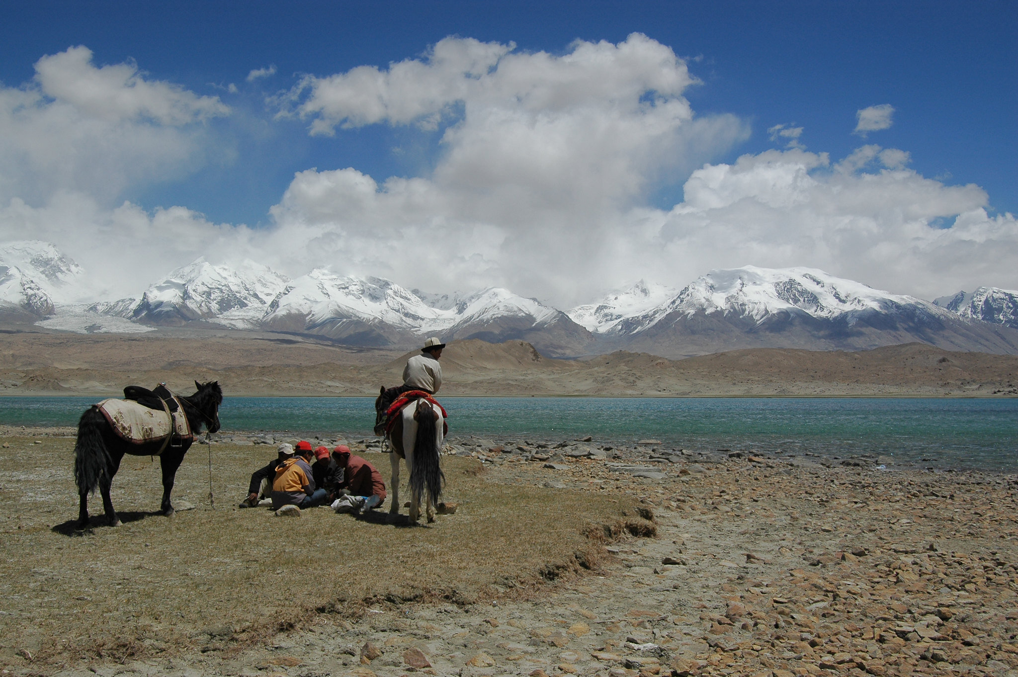 PICTURED: A group of Uighurs take a break from traveling across the vastness. Photo credit Richard Weil. CC. 2.0.