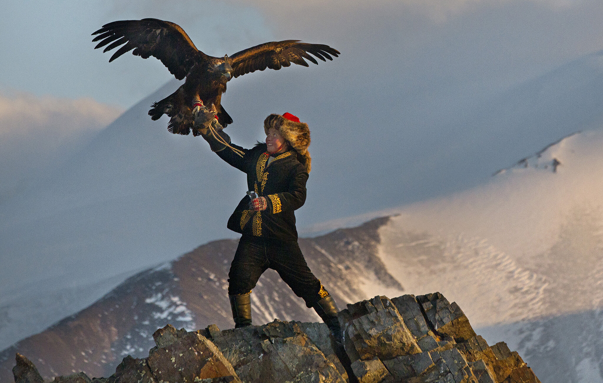 PICTURED: 13-year old Nurgaiv of Kazakhstan hunts the mountains of her home with a golden eagle - carrying on an ancient tradition. Images of Nurgaiv taken by Asher Svidensky went viral in 2014.
