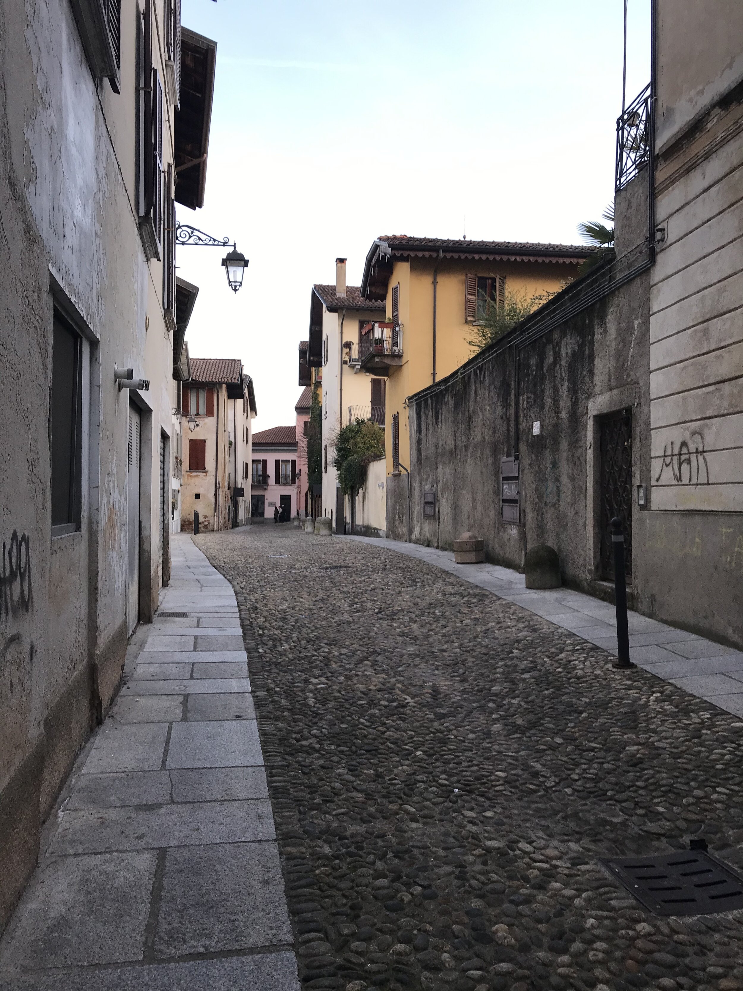  A street unused for a moment in Arona, even as swarms of people frequent the strand. 