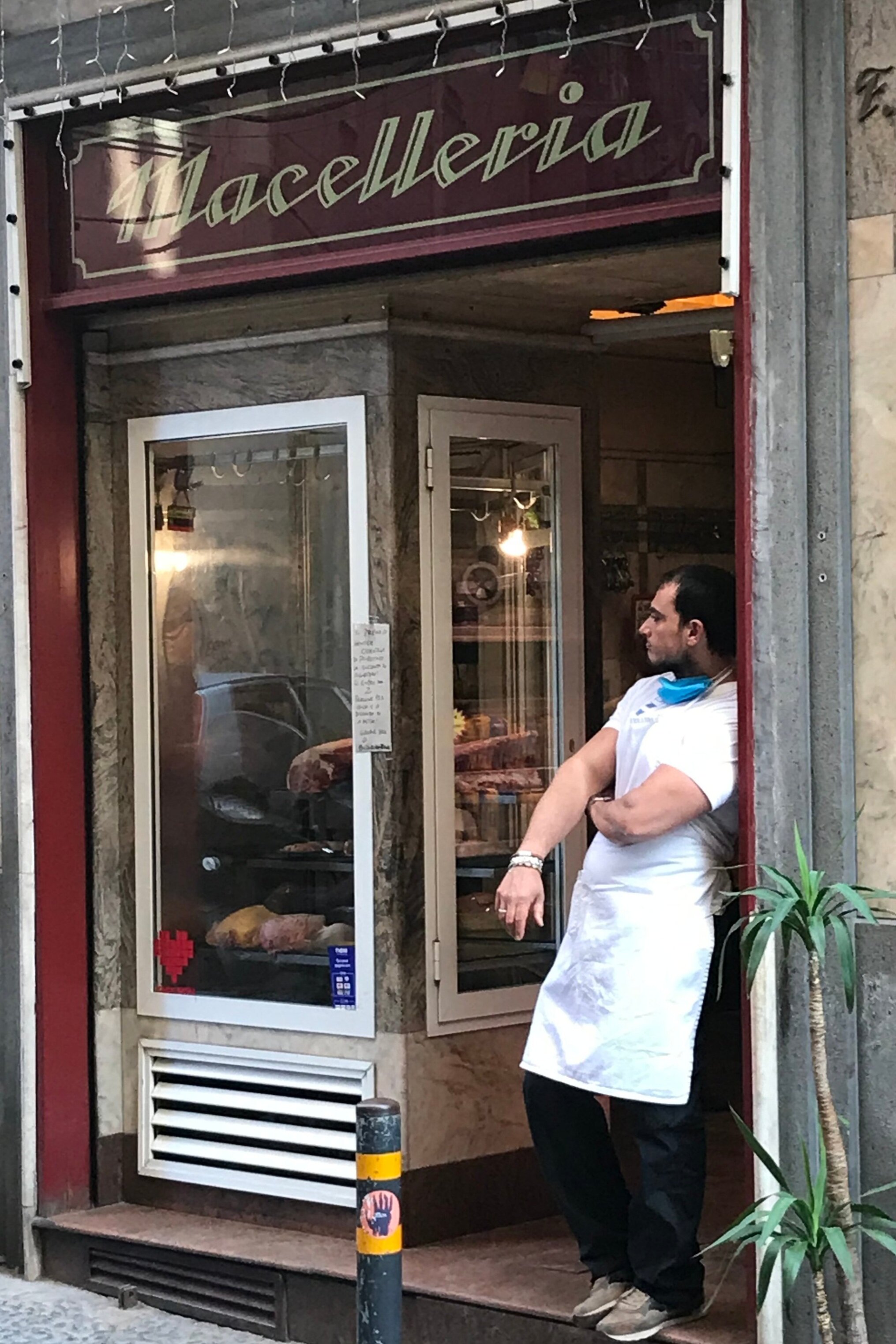   PICTURED:  A  maceliere  or butcher, enjoys a cigarette on a warm morning after finishing preparations for the day.  