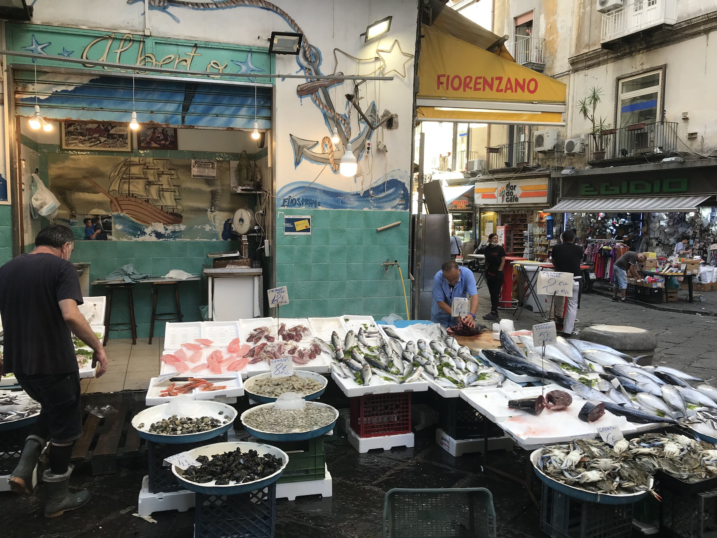   NAPLES, Italy: August 7th, 2020. PICTURED:  A fishmonger prepares his stall for the morning rush, when all his catch is likely to be sold by lunchtime. 