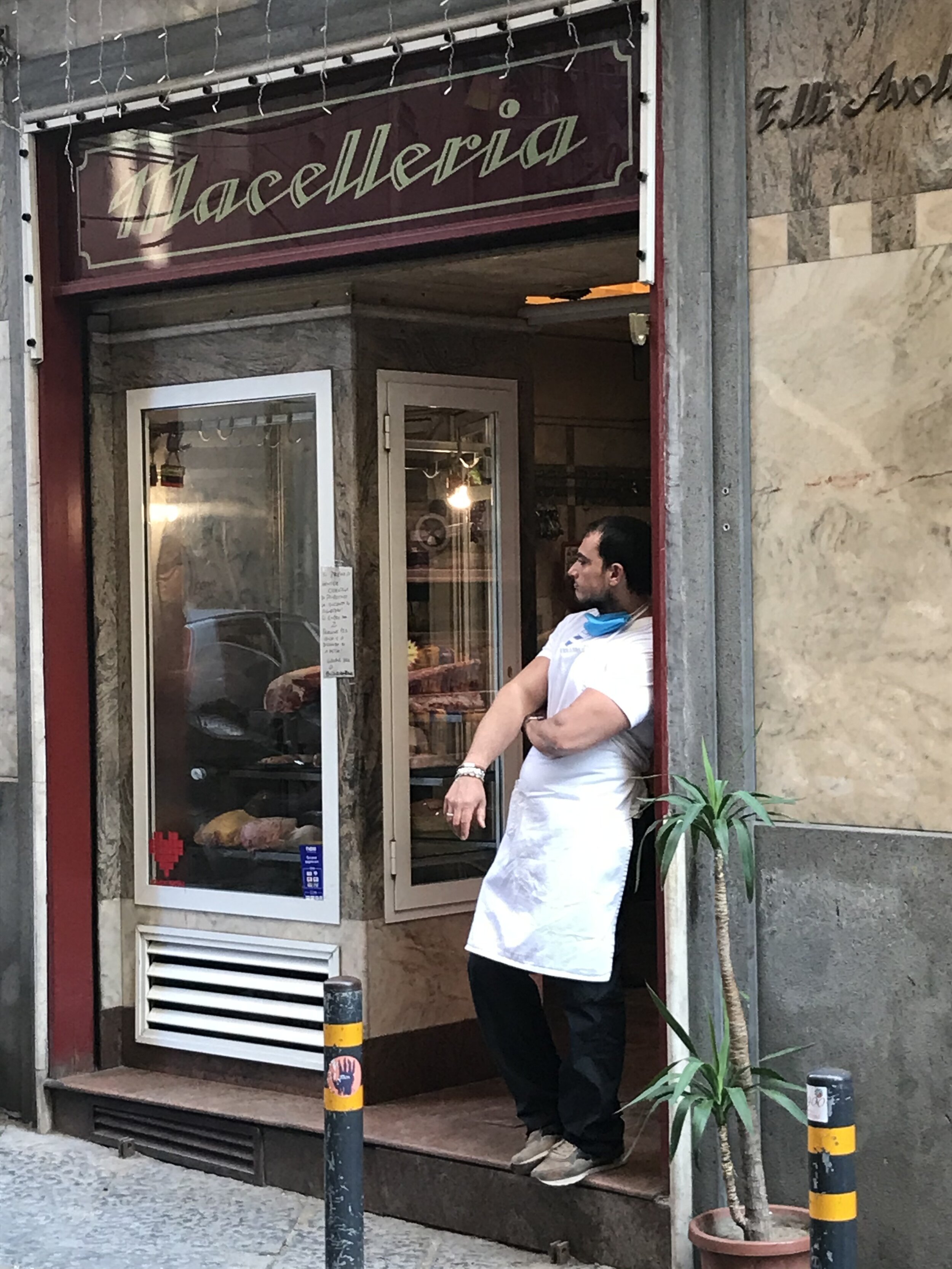   NAPLES, Italy: August 7th, 2020. PICTURED:  A  maceliere,  or butcher, enjoys a cigarette in the early morning after finishing preparations for the day’s work. 