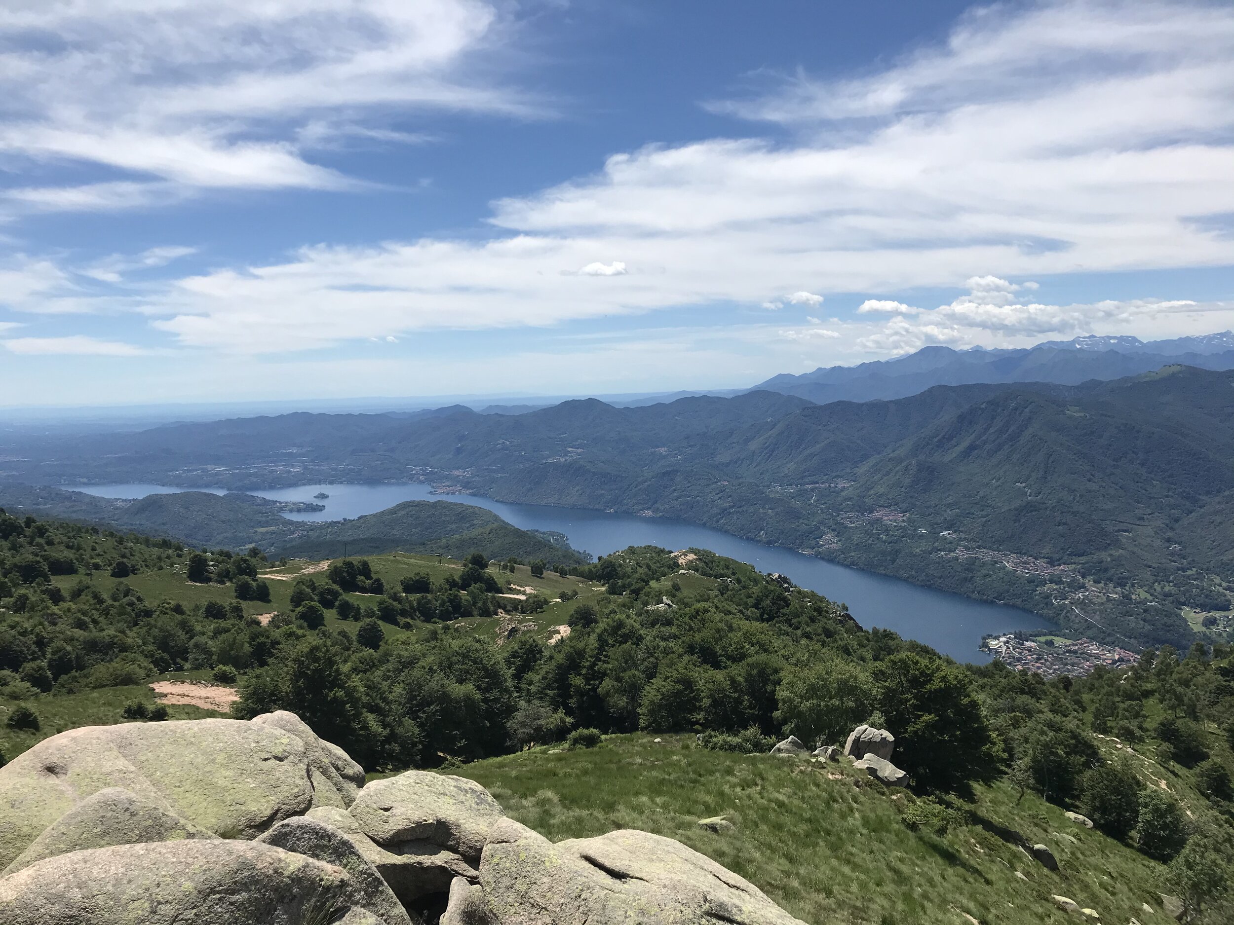 MOTTARONE, Piedmont, Italy. June, 2020. PICTURED: Lago d’Orta reveals its slender nature to hikers upon the summits of Mottarone, 24 kilometers by car above the lakes of Maggiore and Orta.