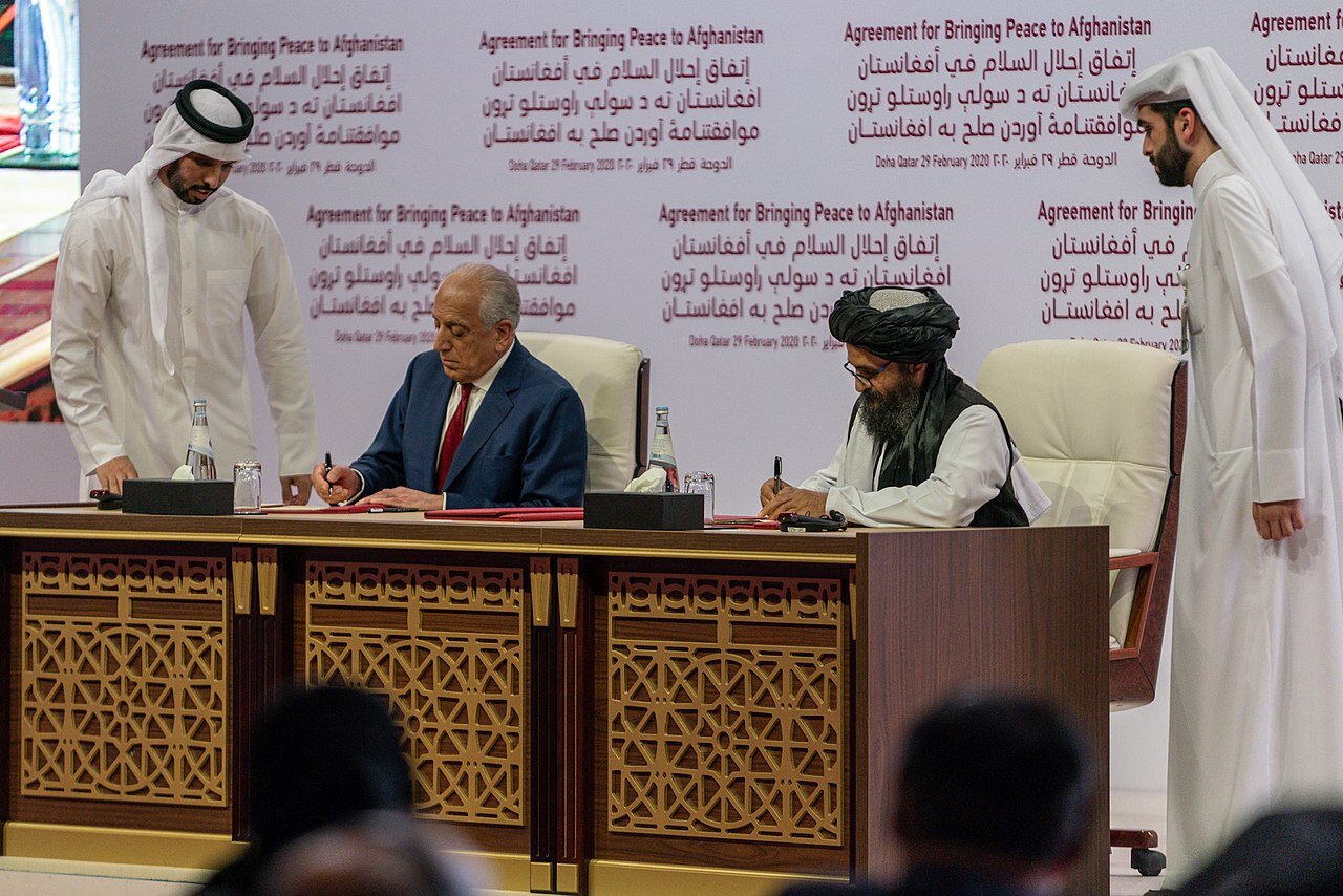 DOHA, Qatar. February, 2020. PICTURED: The Doha Agreement being signed by Taliban emissaries and the U.S. Special Rep. to Afghanistan, Zalmay Khalilzad.