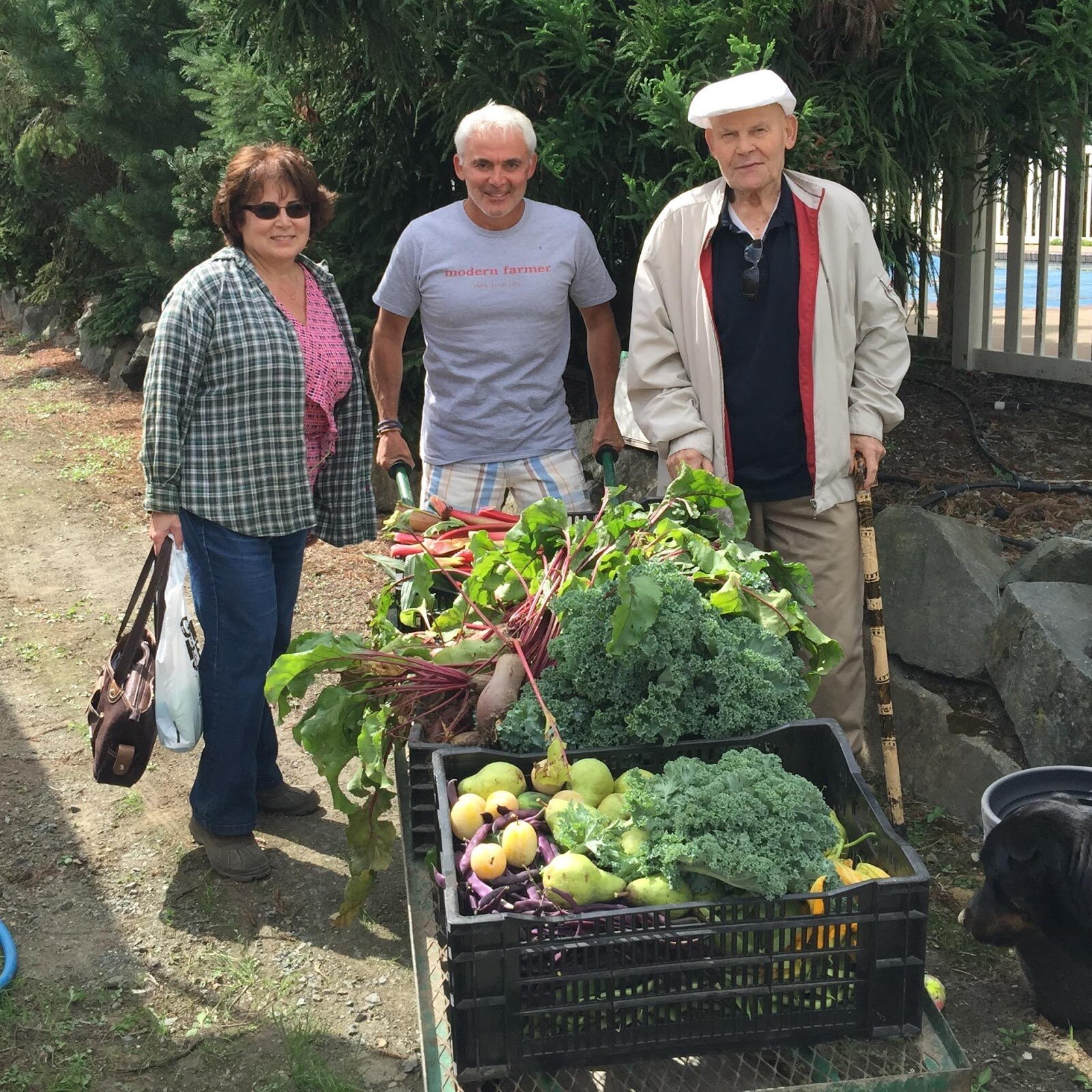 PICTURED: Frank Giustra, Owner and Publisher of Modern Famer, with his garden harvest next to his parents. Photo credit: Frank Giustra.