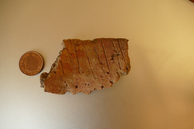 PICTURED: The pottery shard belonging to a large cremation urn, also discovered having been dug up by rabbits. Photo credit: Skokholm Blog. Released.