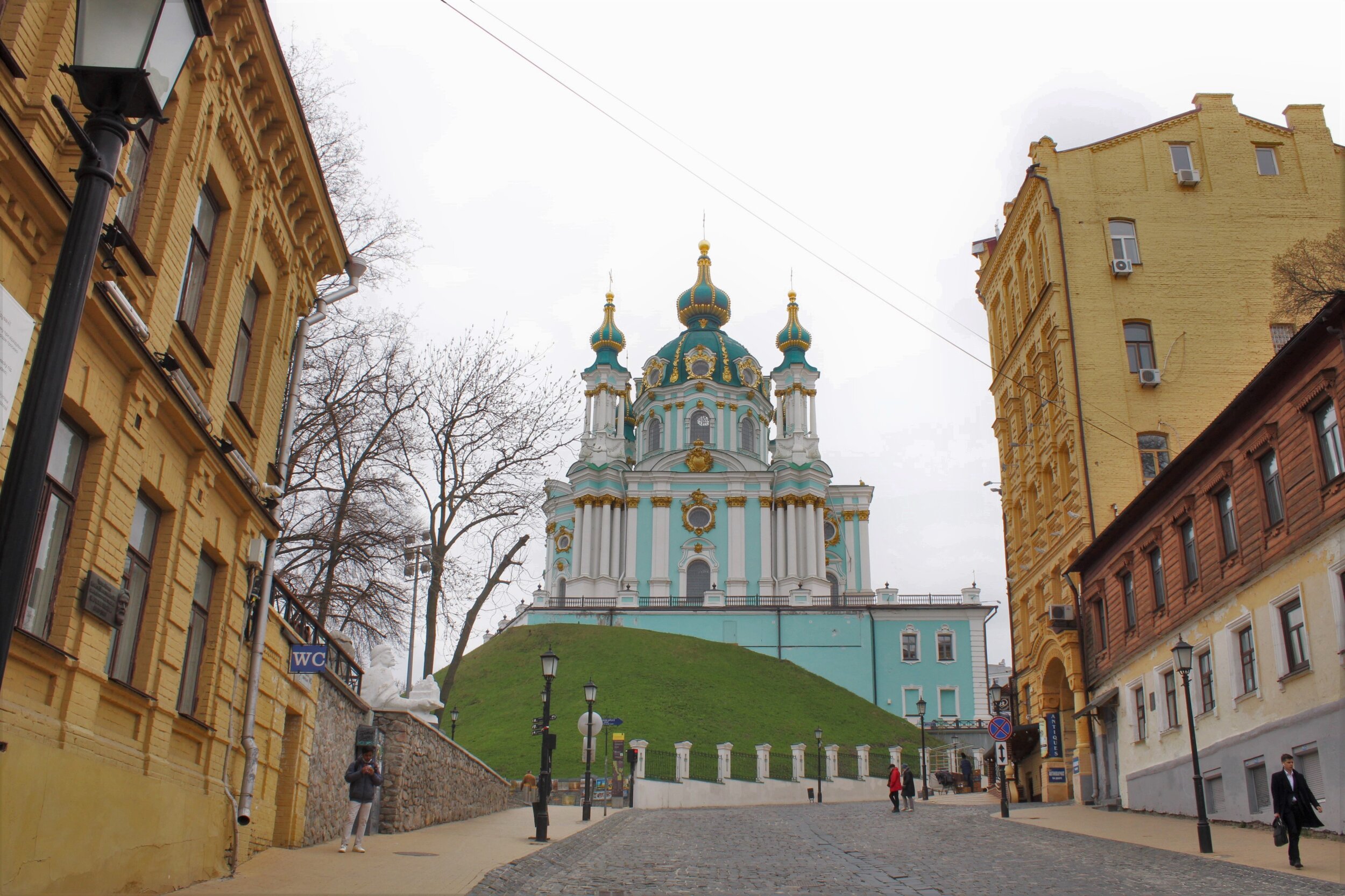   KYIV, Ukraine. April 19th, 2021. PICTURED:  St. Andrew’s Cathedral looks down over Andriivs'kyi Descent, an old cobbled street, lined with theaters, into the Podil neighborhood.  