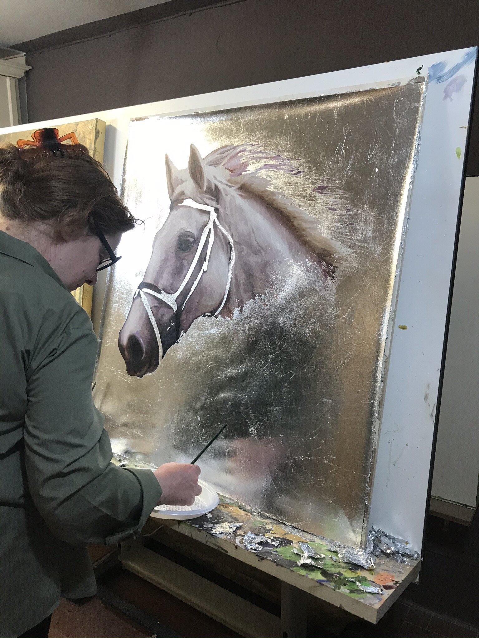 PICTURED: Sandra Petreni applies the finishing touches to a commissioned painting. She told me that riders often ask for portraits of photographs of their horses due to Sandra’s excellence at ultra-realistic recreations.