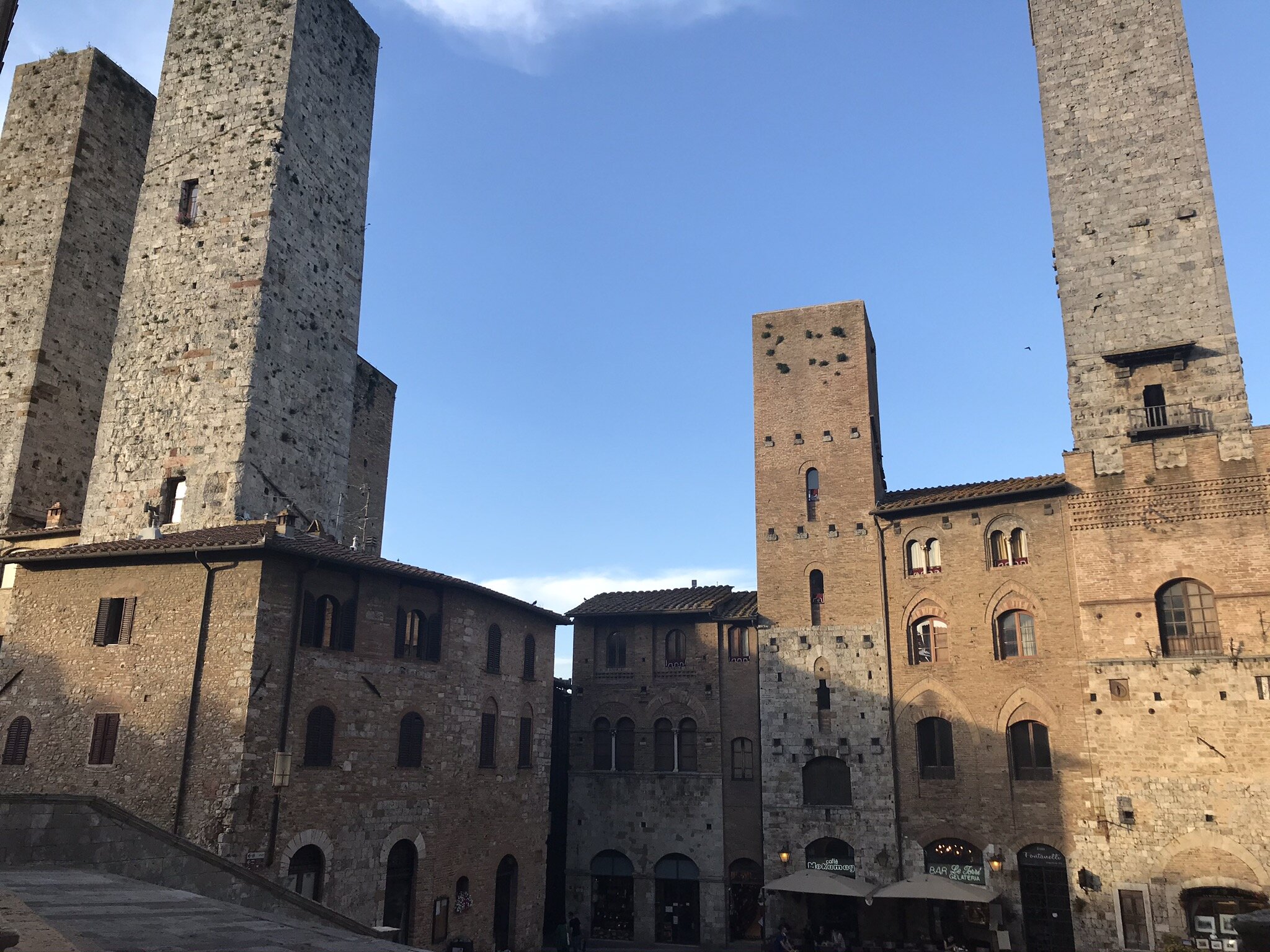 SAN GIMIGNANO, Siena, Italy. June 3rd, 2021. PICTURED: 5 of the 11 city towers, as seen from the steps of the Piazza del Duomo, line the perfectly preserved Medieval streets of San Gimignano: an absolutely stunning place to spend half a day.
