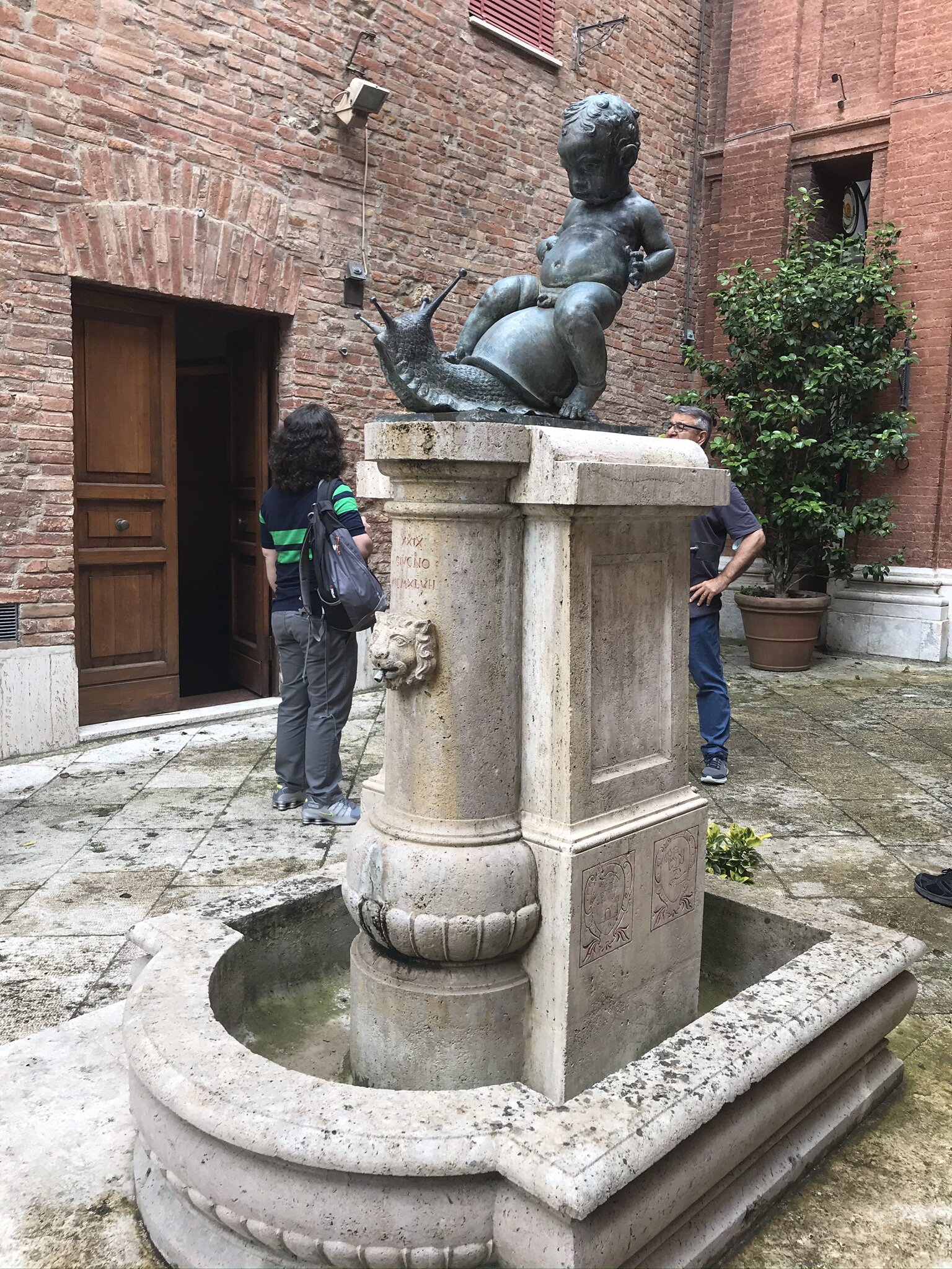 PICTURED: The baptismal font of the Society of the Snail, carved in the 1500s, said to spout wine upon the contrada’s victory in the Palio. A friend told me that maybe only 30% of Siena’s population has not been baptized in one of these fonts.