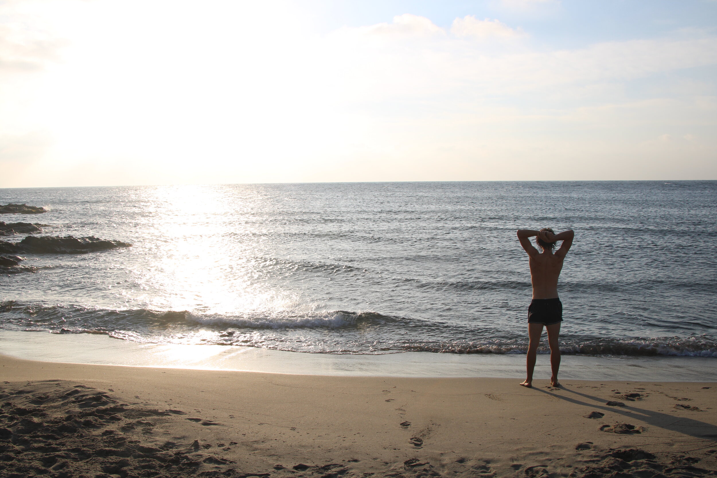   PUNTA BAJA, Almeria, Spain. October 3rd, 2021. PICTURED:  A swimmer enjoys the warmth of the sun in the early morning on a beach near Punta Baja, in western Cabo de Gata.  Photo credit:  Andy Corbley ©. 