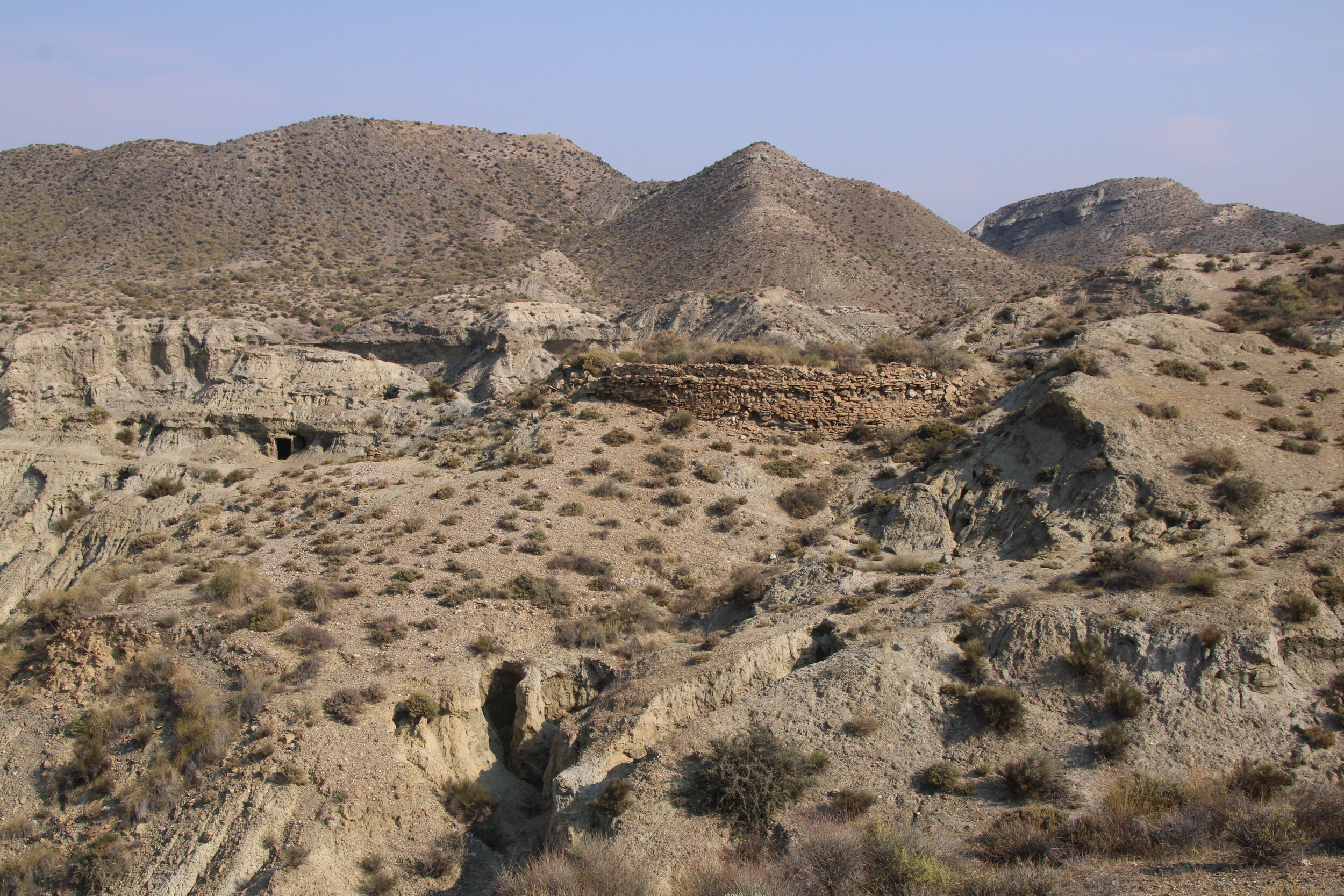  THE TABERNAS, Almeria, Spain. October 2nd, 2021. PICTURED:  Signs of antique habitation, or the remains of a location film set sit camouflaged in the desert landscape of Tabernas.  Photo credit:  Andy Corbley ©. 