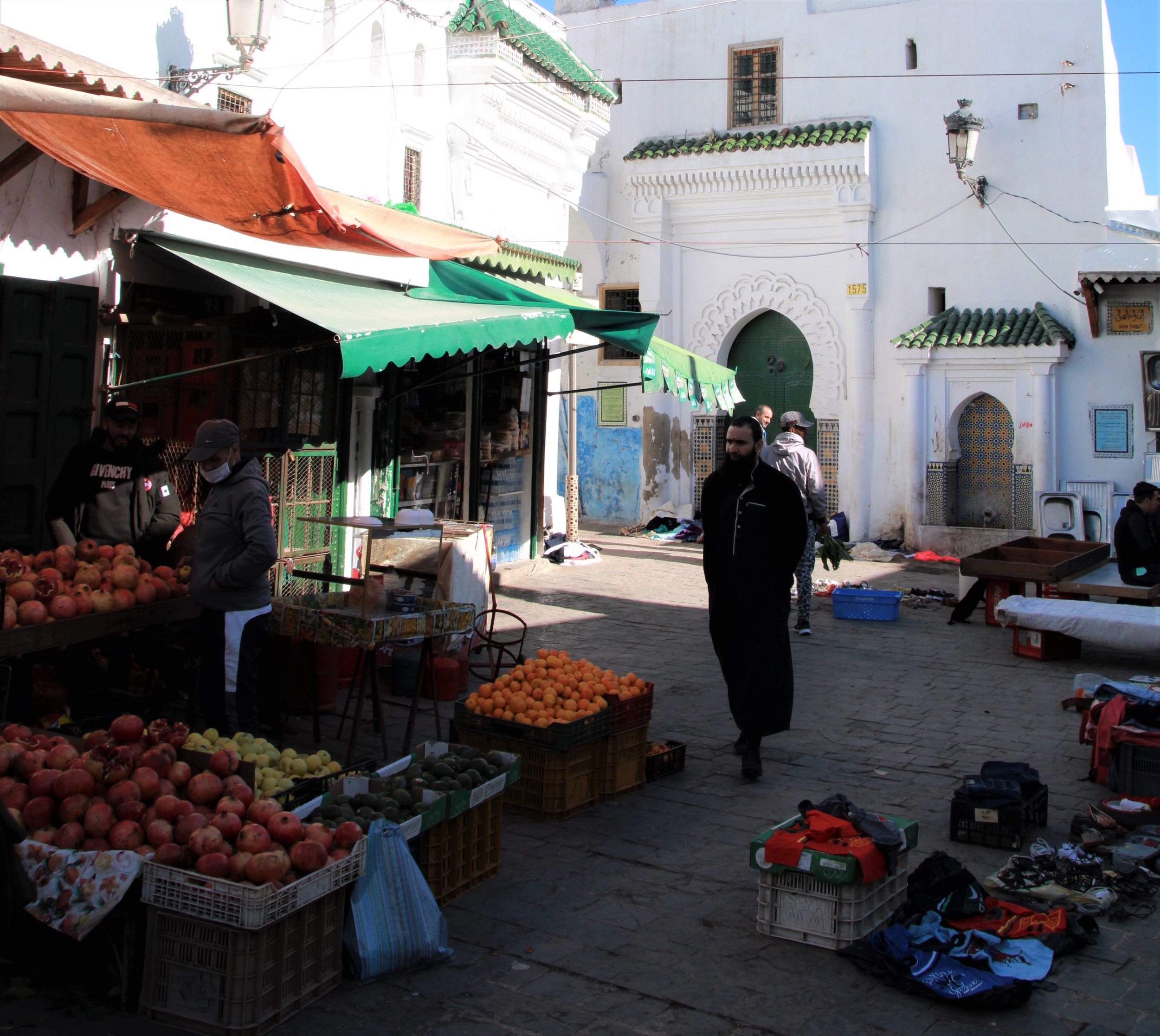  PICTURED: A man in a Jebala walks in front of one of the 17th century mosques in the old medina. PC: Andrew Corbley © 