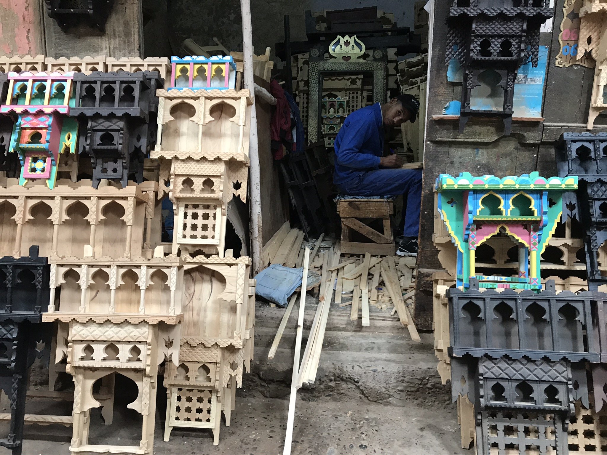  PICTURED: An artisan makes shelves in the traditional Moroccan style inside the souk of Rissani. PC: Andrew Corbley © 