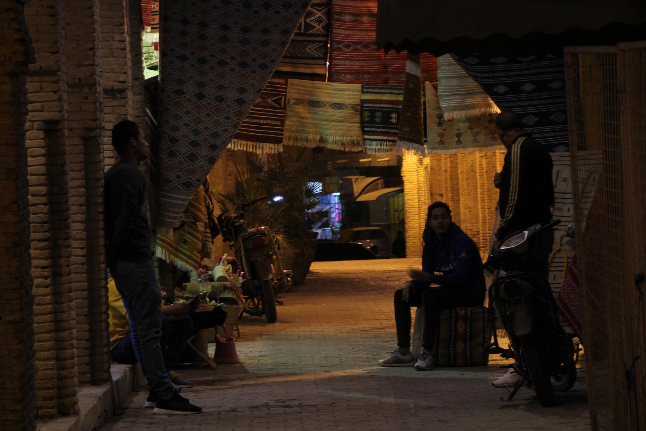  PICTURED: Carpet salesmen chat after shops close for the night. PC: Andrew Corbley © 