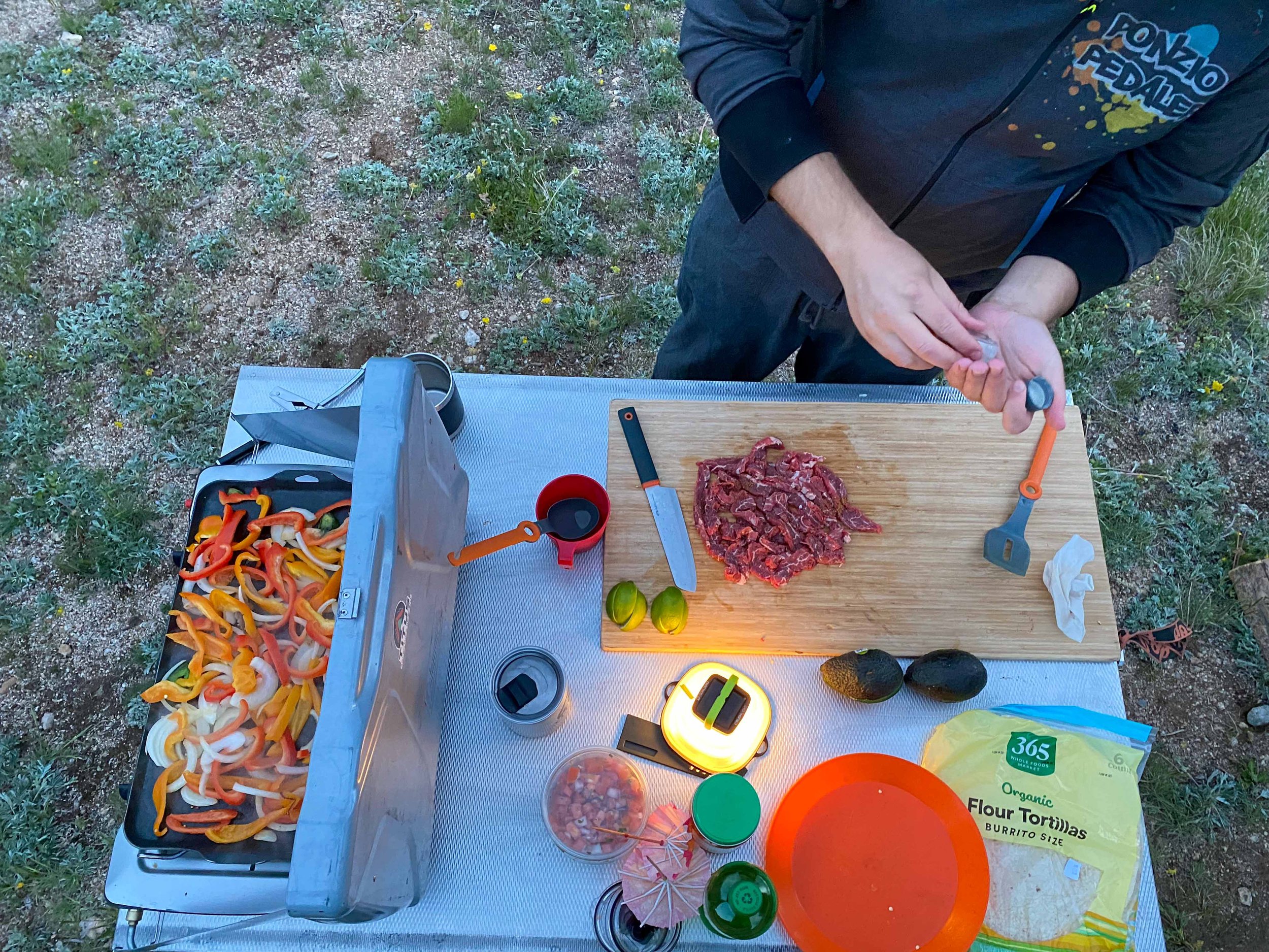Making steak and peppers in the camp kitchen, with Titus Adventure Company, camping & 4WD rentals in Denver, CO.