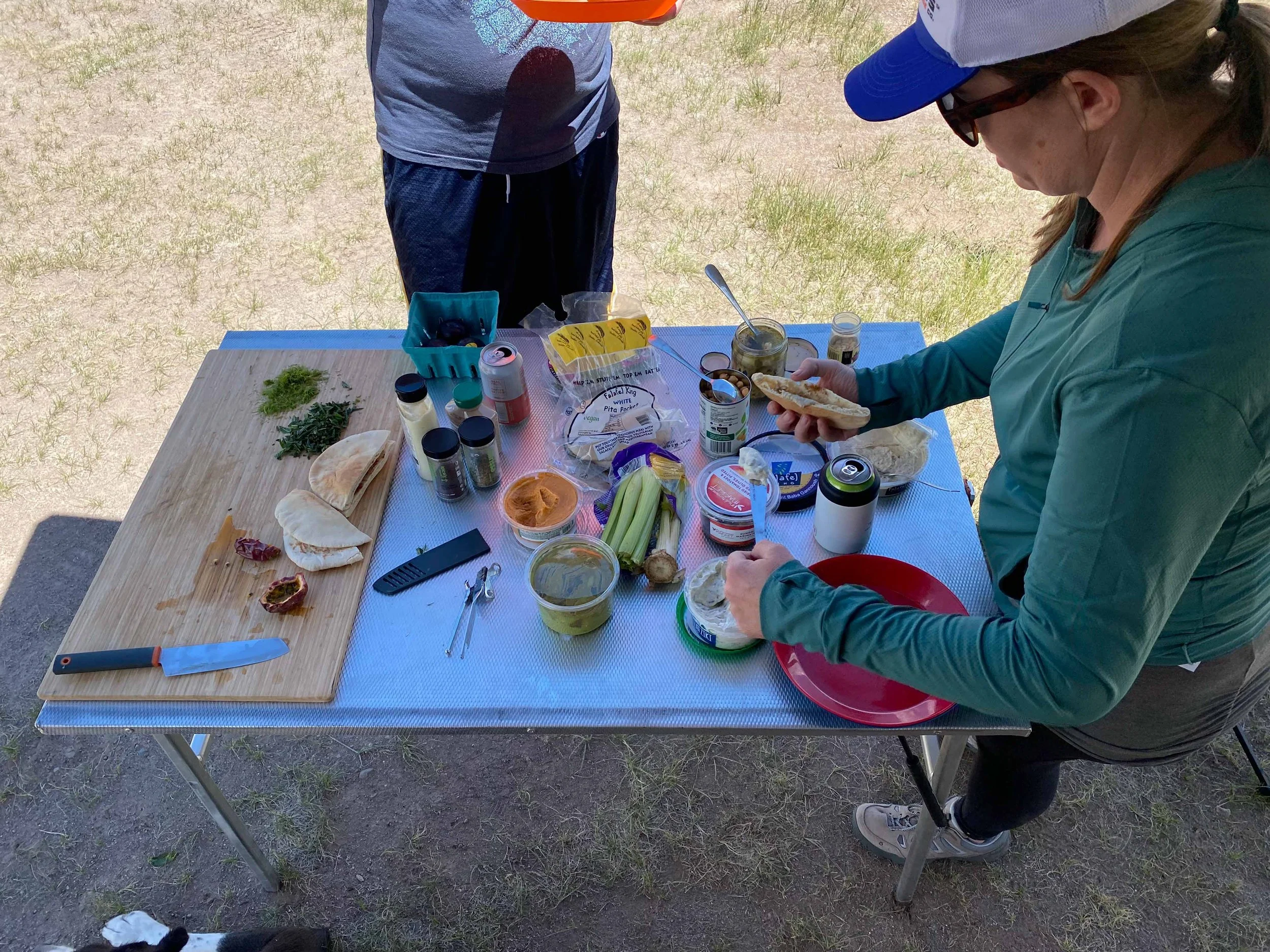 Prepping humus and pita wraps in the camp kitchen. From Titus Adventure Company, 4WD & camping rentals in Denver, CO.