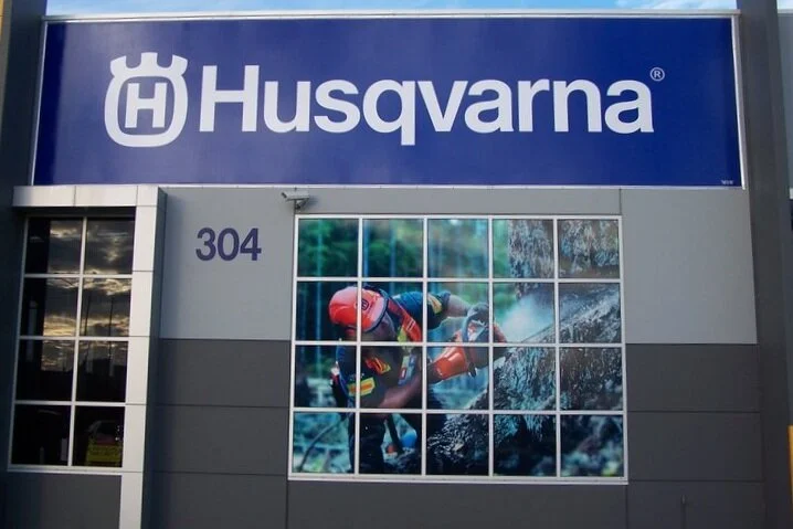 This Husqvarna store we did the signage for creatively uses a form of digital printing on a material used on the windows that allows light to come in and the image to stand out.