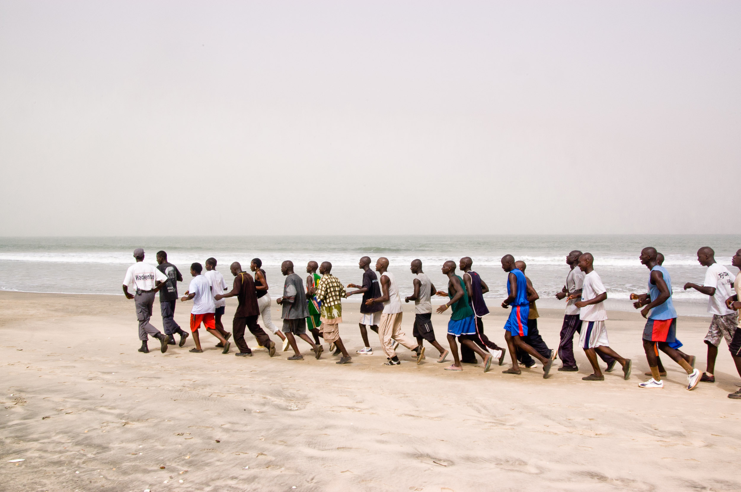  Soldiers jogging and singing on the beach; Military exercise 