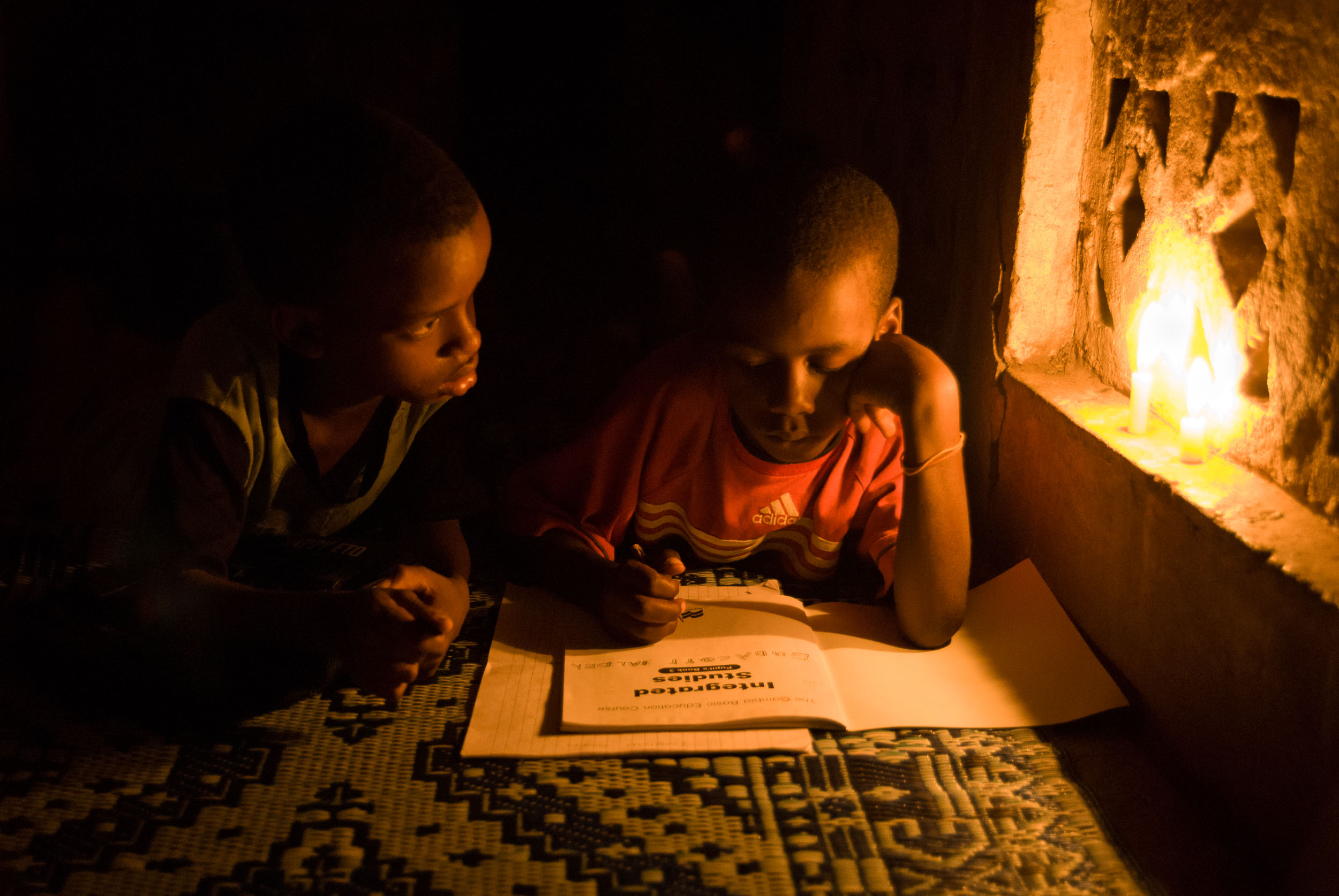  Kids Doing Homework with Candle Light, Gambia, Africa 