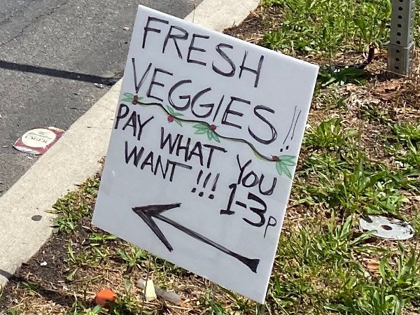 photo of yard sign: "Fresh Veggies | Pay what you want!!! 1-3 p.m.