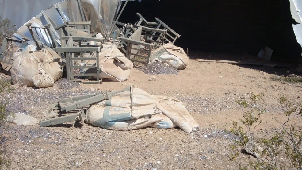 Dimes cover the dirt ground next to I-15 northeast of Las Vegas after a truck carrying $800,000 in the denomination crashed Tuesday, May 8, 2018. (Photo courtesy Nevada Highway Patrol)