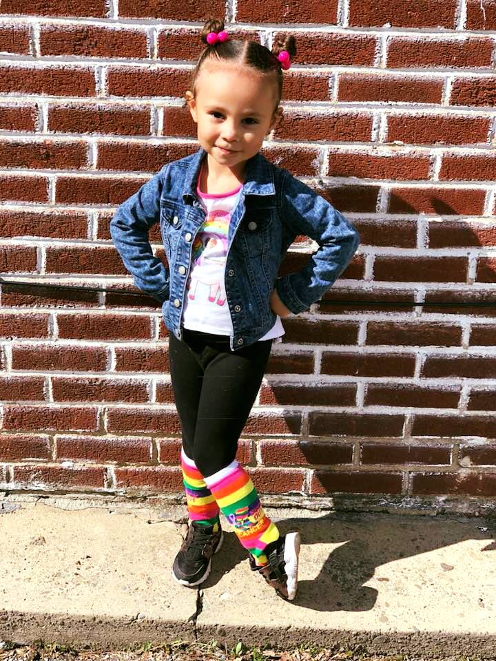 Little girl wearing Sock Out Cancer Socks