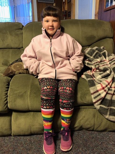 Little girl wearing Sock Out Cancer socks