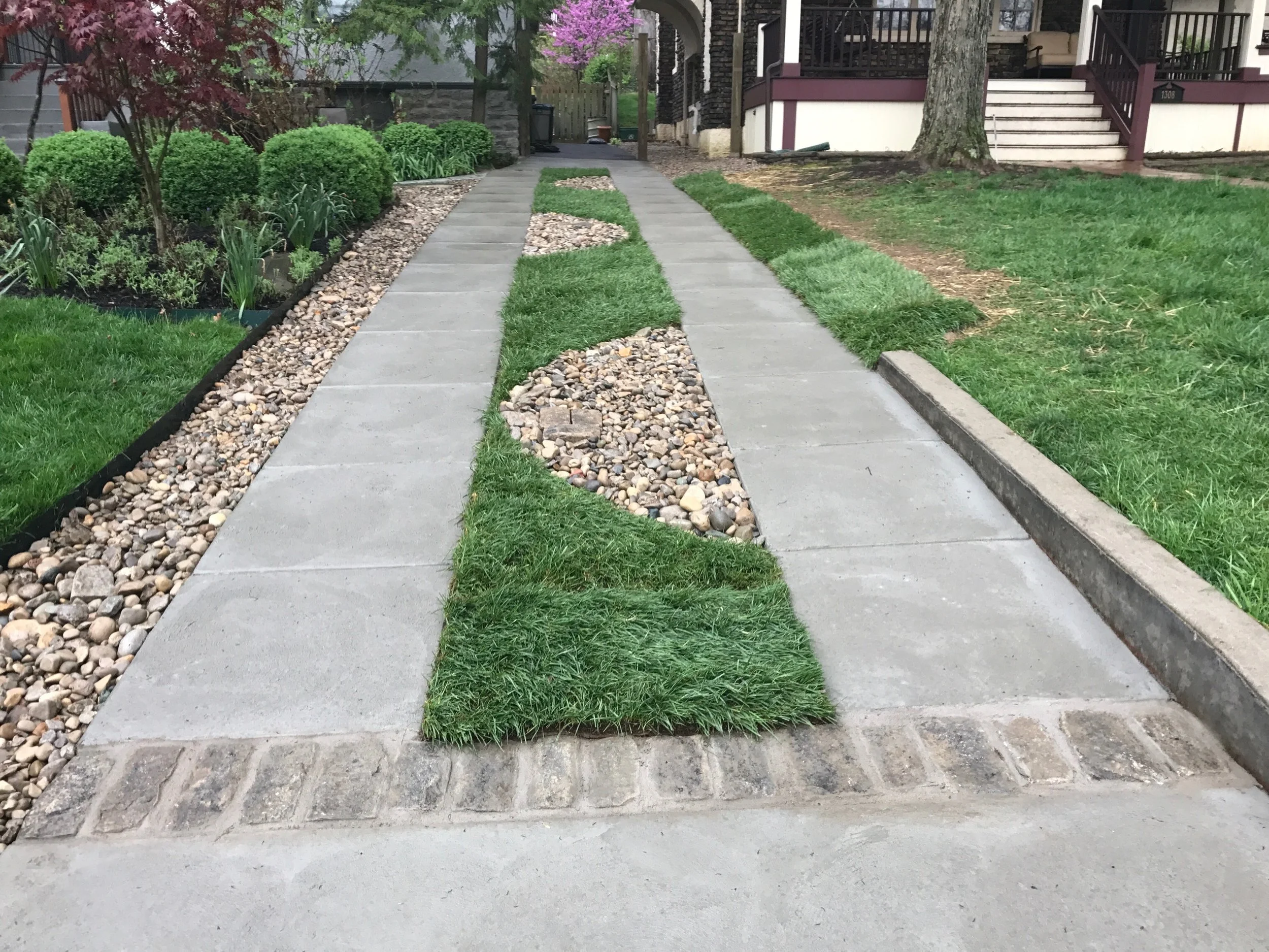 Traditional Concrete Driveway Ribbons with Pavers, Decorative Gravel, Curbing, Public Apron and Sidewalk
