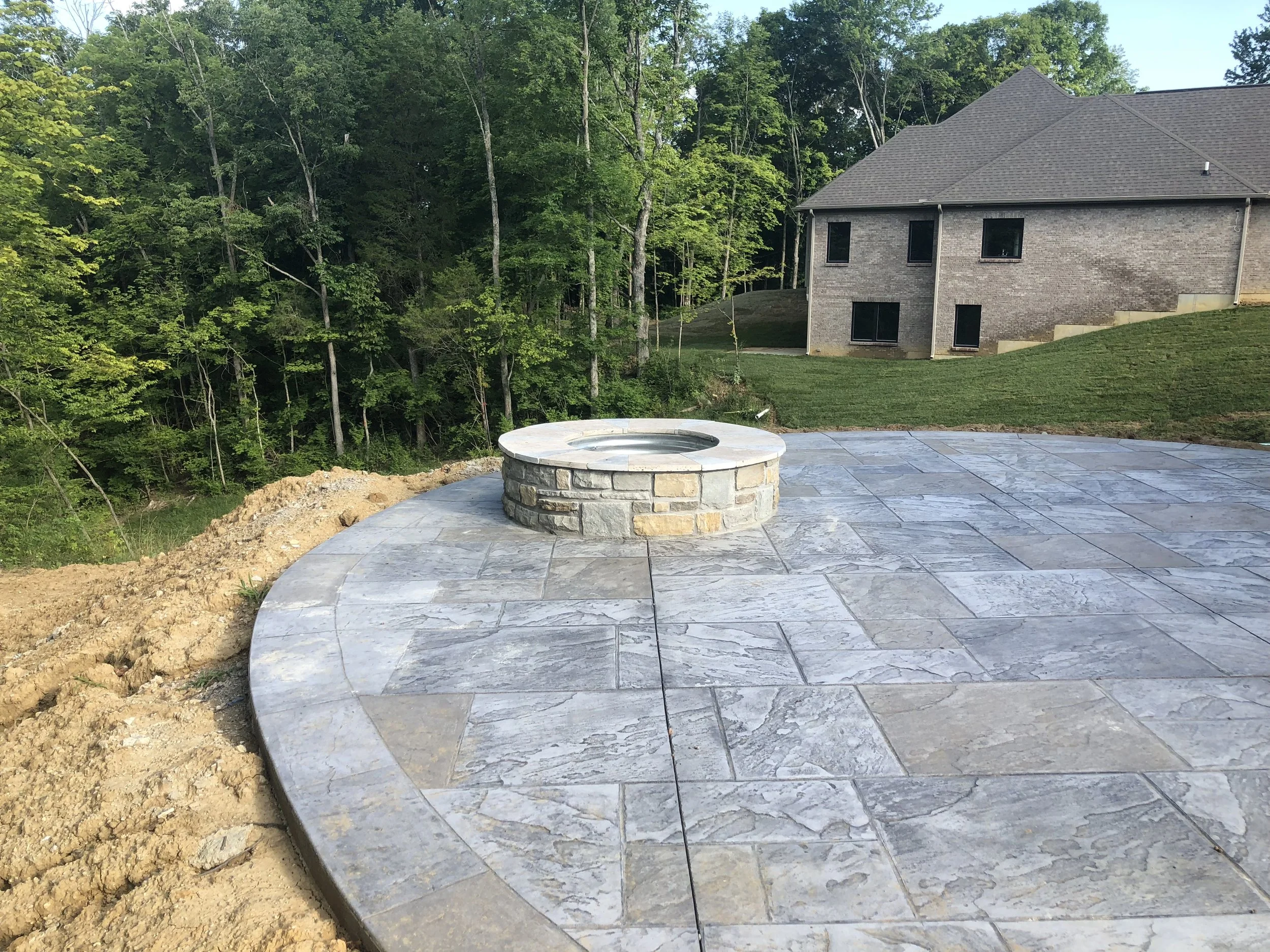 Stamped, Stained Concrete Rear Patio with Stone Built-in Fire Pit