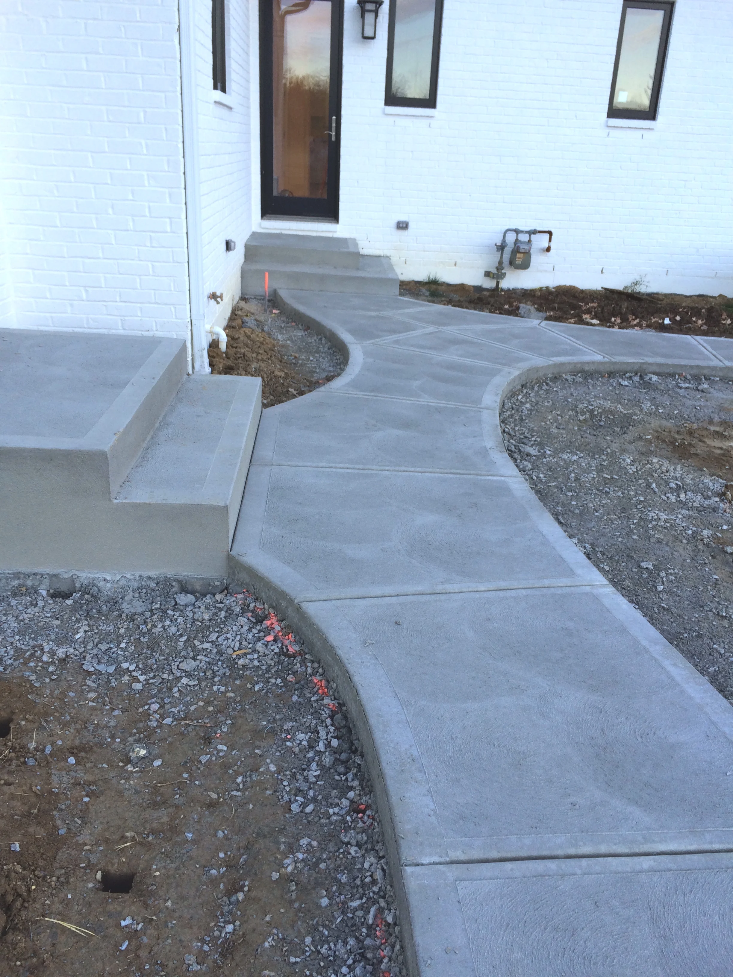 Traditional Concrete Rear Walkway System with Steps and Landings Swirl Finish