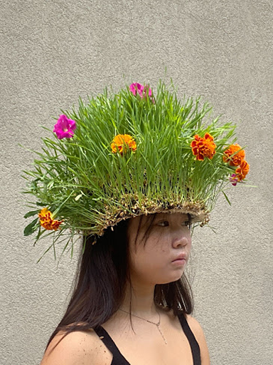 A ONE Lab student showcasing her project - a headgear made out of wheatgrass  (Copy)
