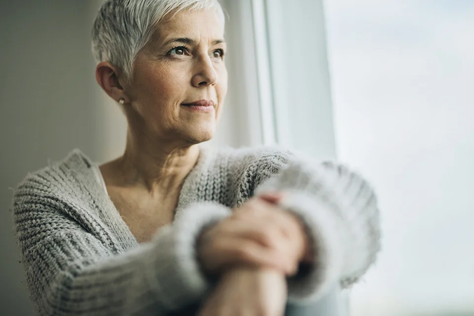 Woman_With_Capital_by_window.jpg