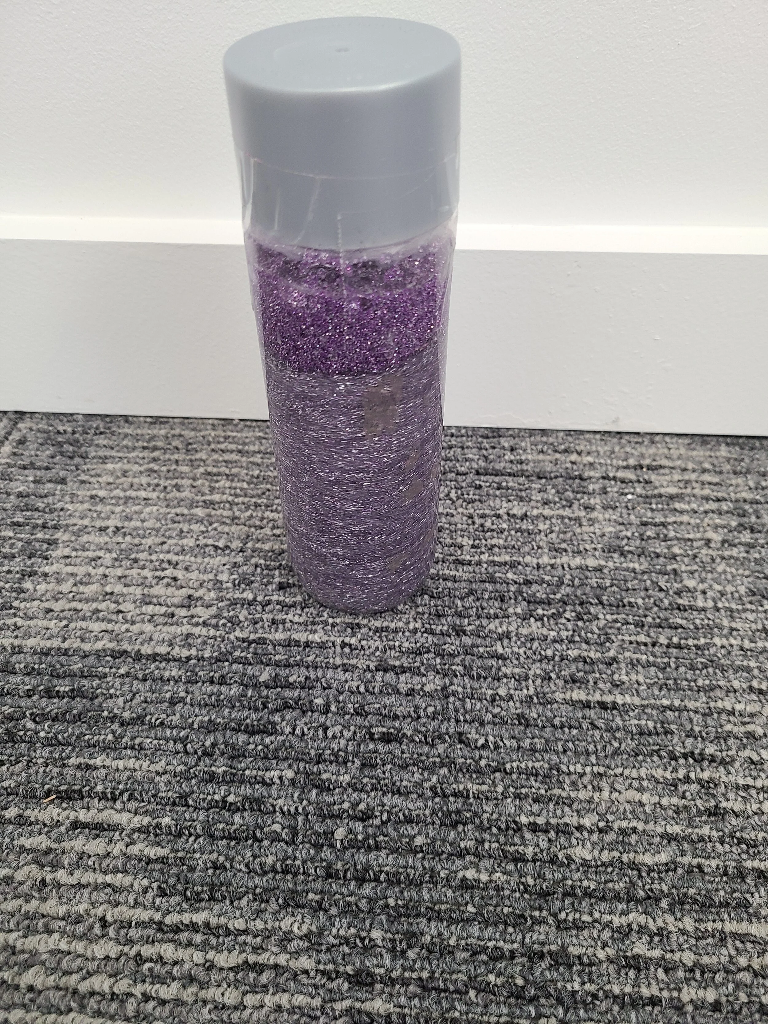 Glitter bottle with purple glitter