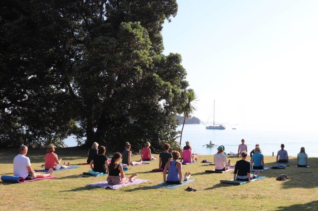 Yoga at Sullivan's seated with dinghy in background .jpg