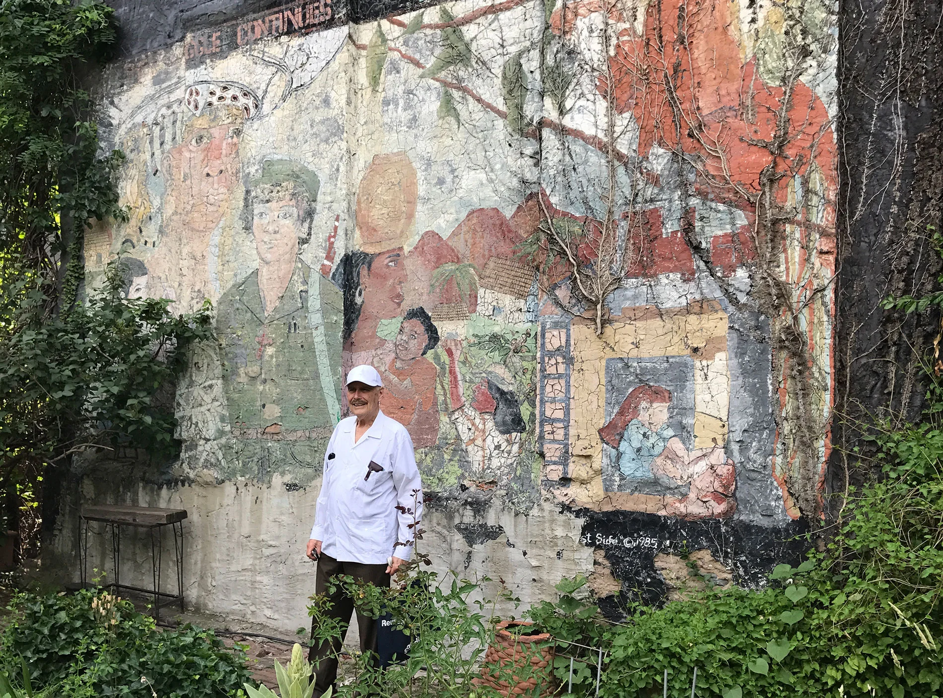 Jim Cockcroft in front of Rikki Asher’s mural in La Plaza, one the two extant murals. Photo © Kristin Reed
