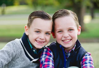 two brothers smiling outside