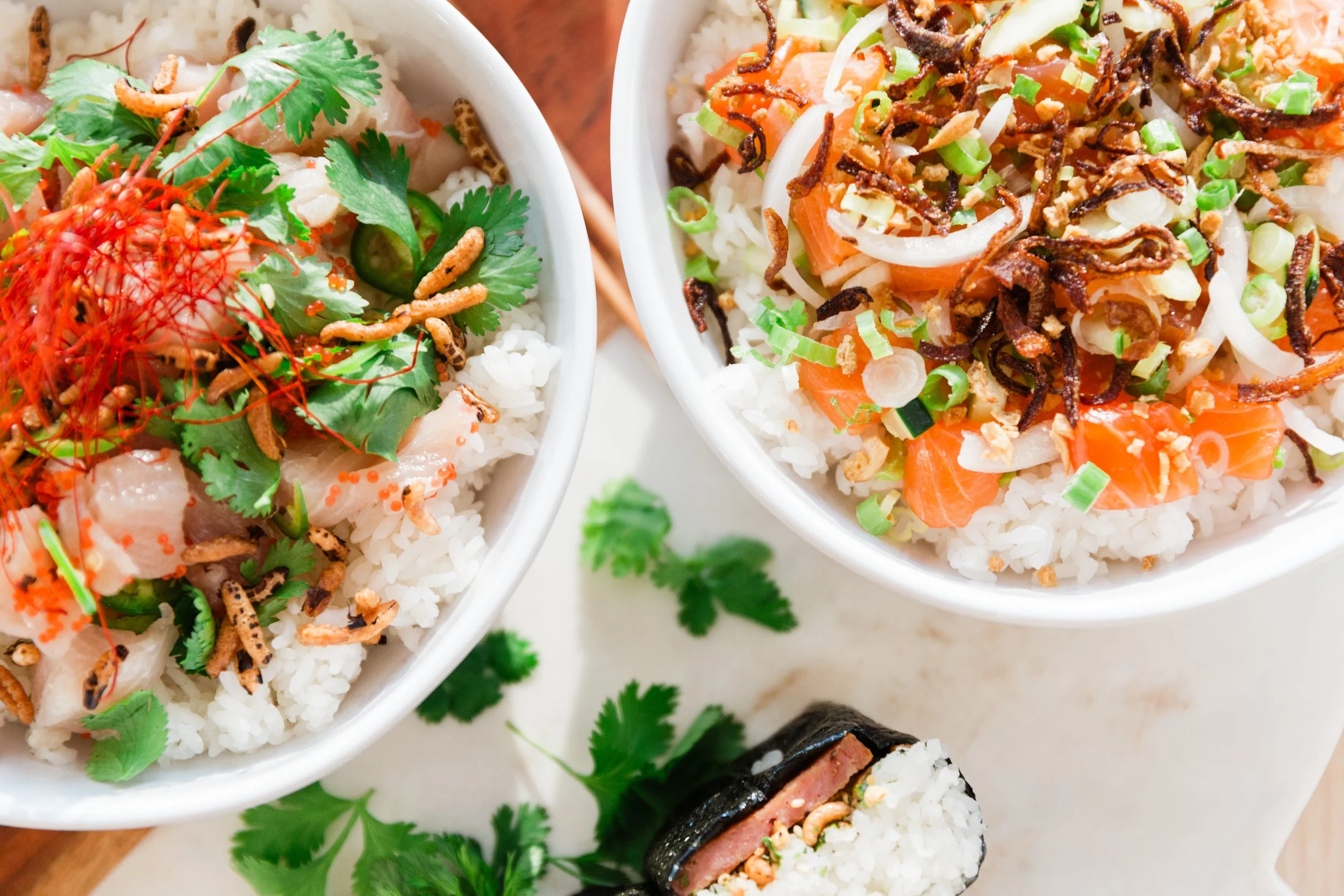 A poke bowl with salmon and one with hamachi