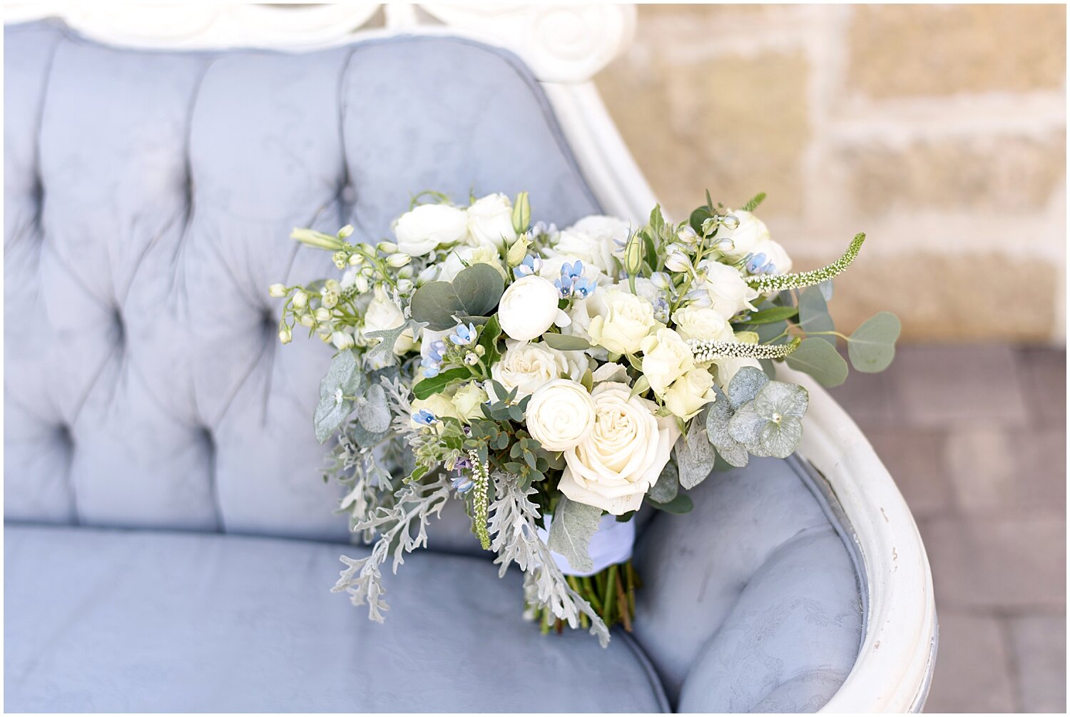  bride’s wedding bouquet with baby blue and white flowers 