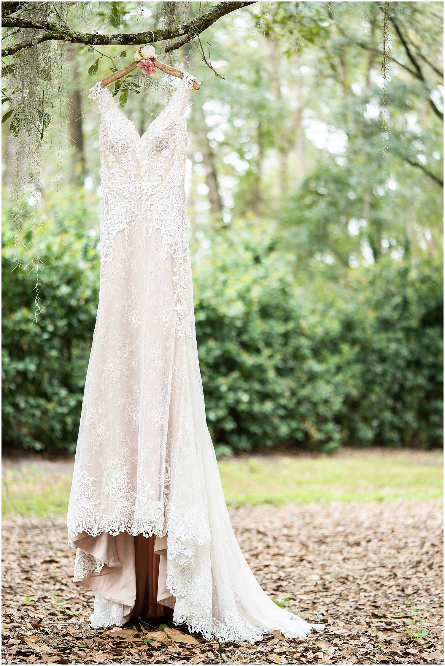  bride’s wedding dress hung up on a tree 