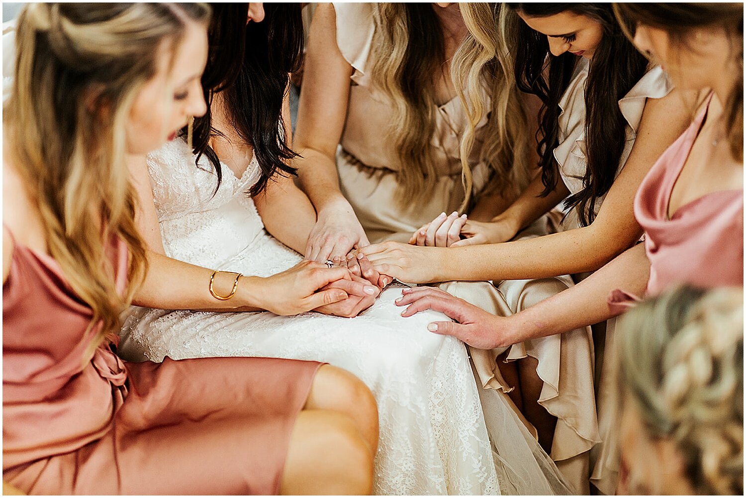  bride and bridesmaids praying before the wedding ceremony 