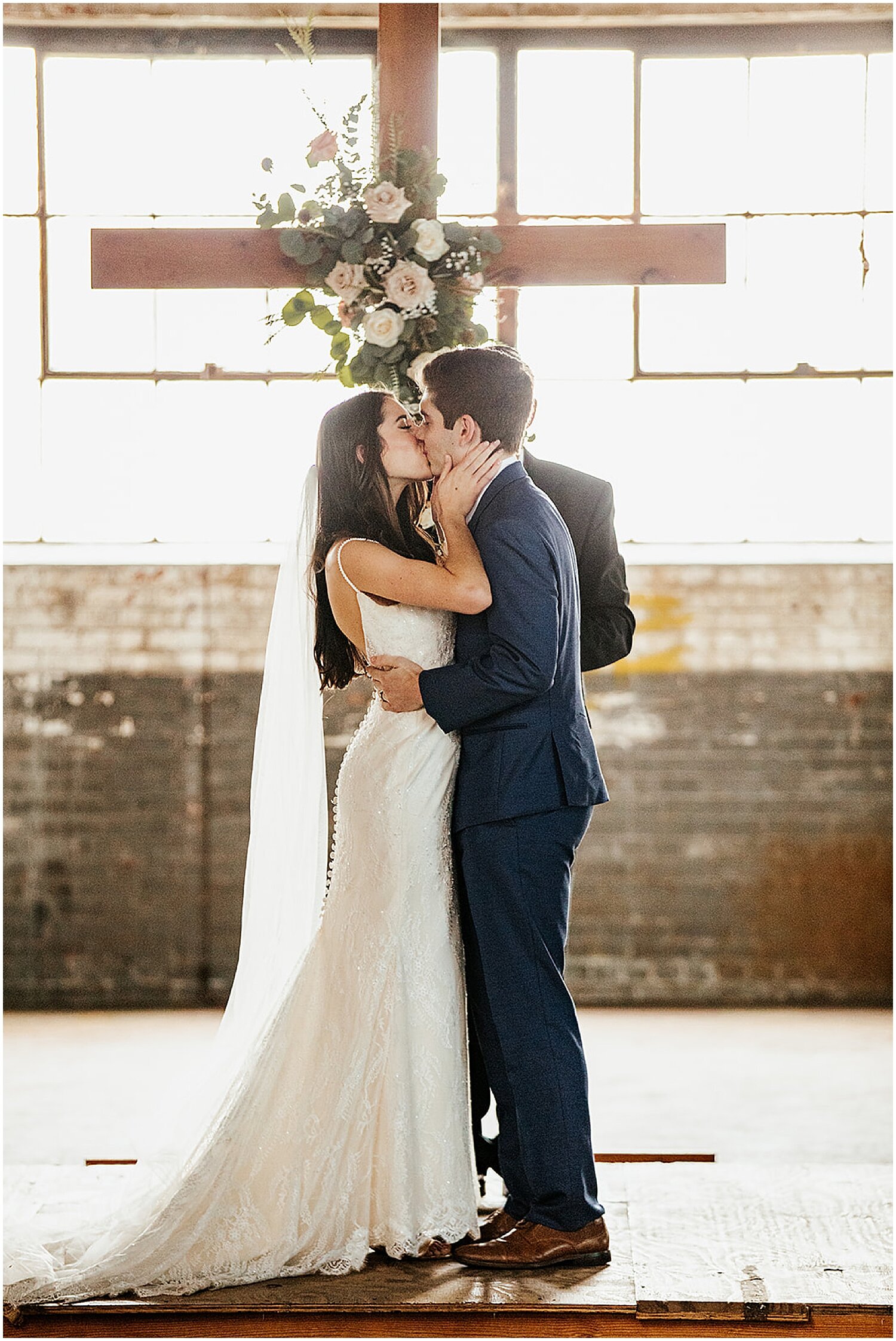  bride and groom kiss at their wedding ceremony 