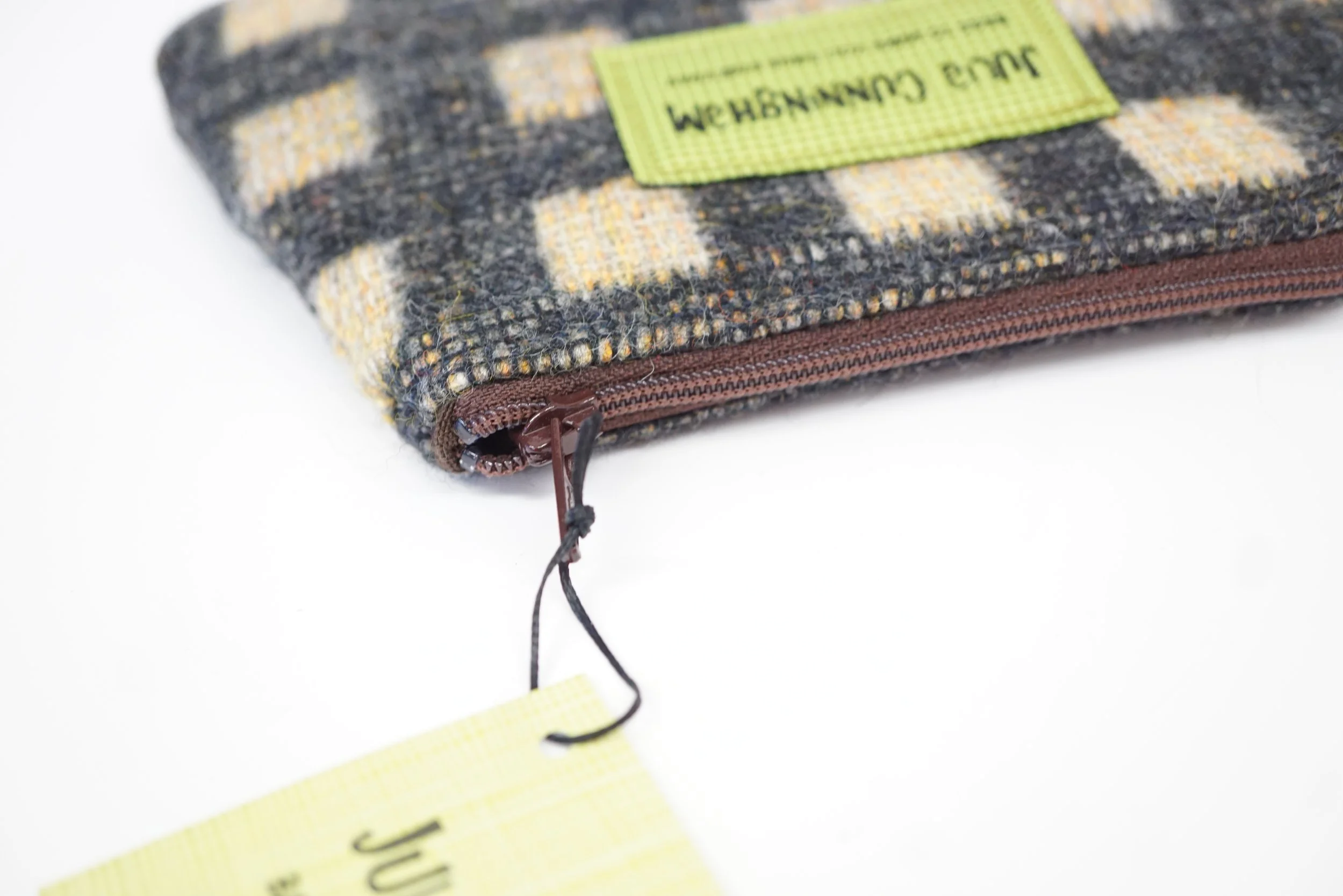 demonstrating zip datail of Black and cream vintage Hinnigan tweed zipped storage purse, handmade in Scotland by Julia Cunningham