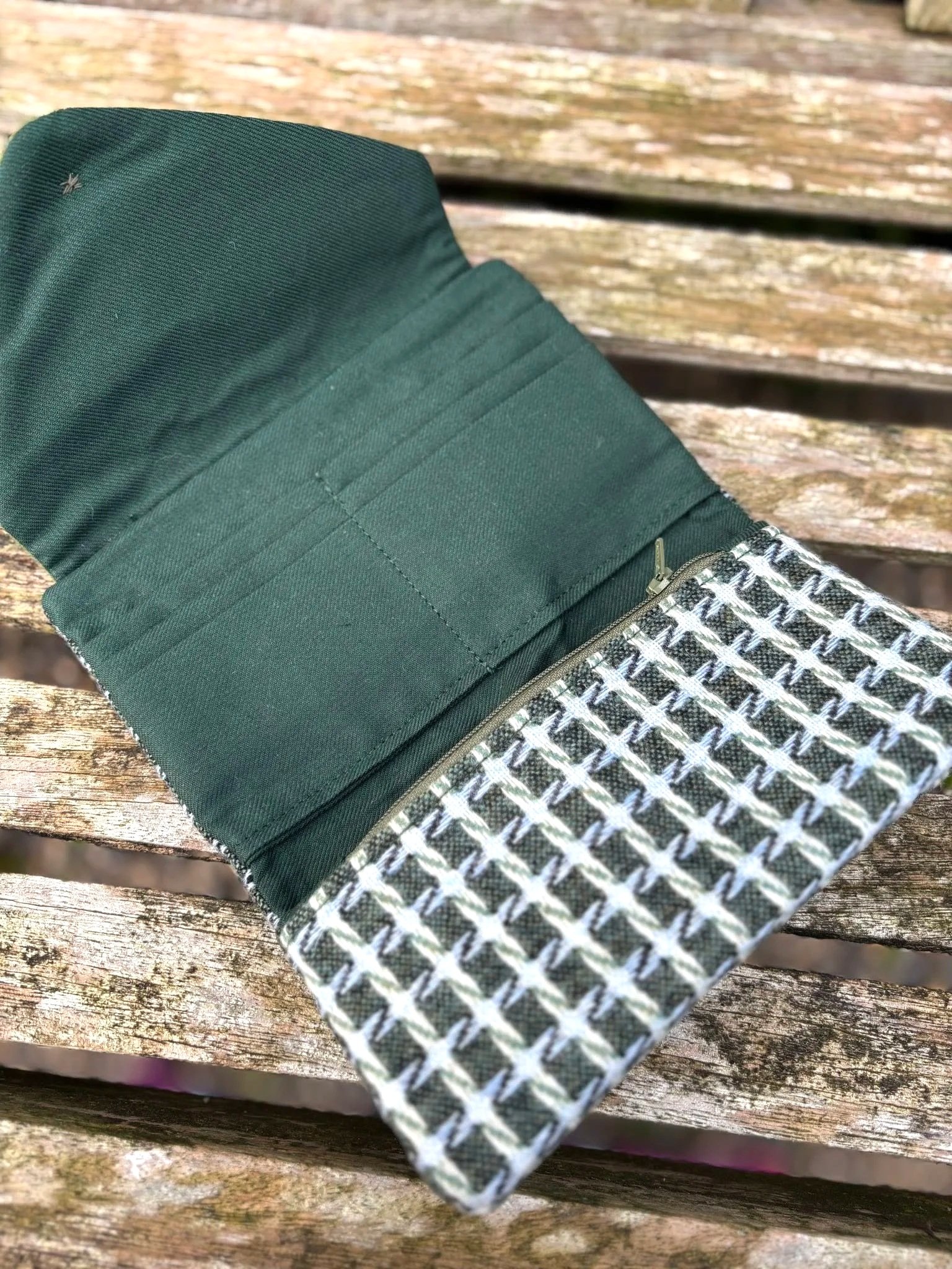 Interior of handmade Scottish clutch purse showing card slots, Hinnigan zip pocket and green lining by Julia Cunningham