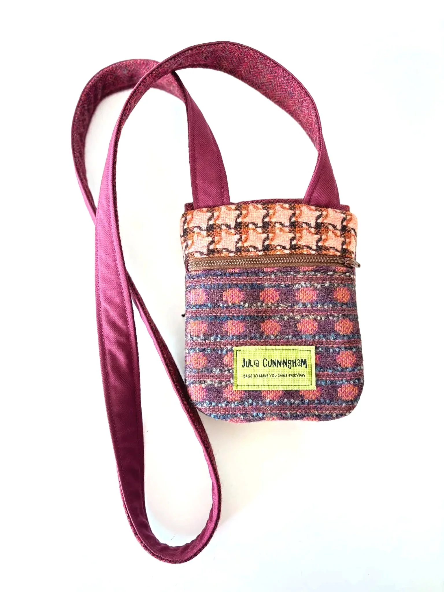 back of a cross body tweedling showing the zip pocket and hinnigan tweeds