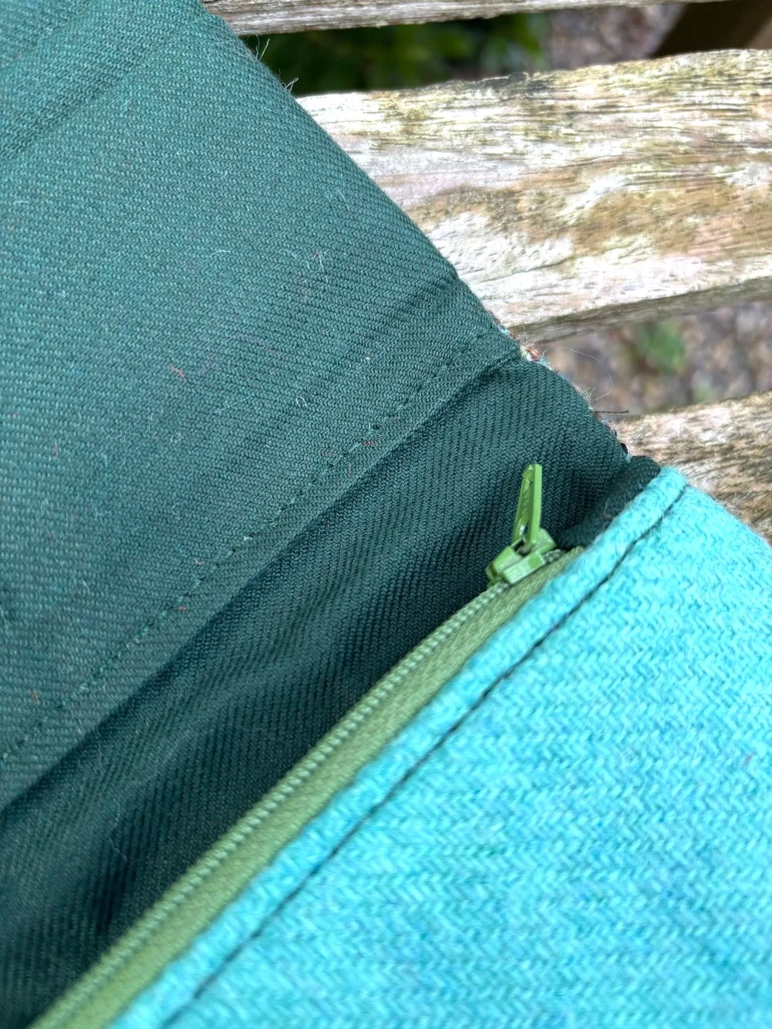 Interior detail of handmade Scottish clutch purse showing  zip pocket and green lining by Julia Cunningham