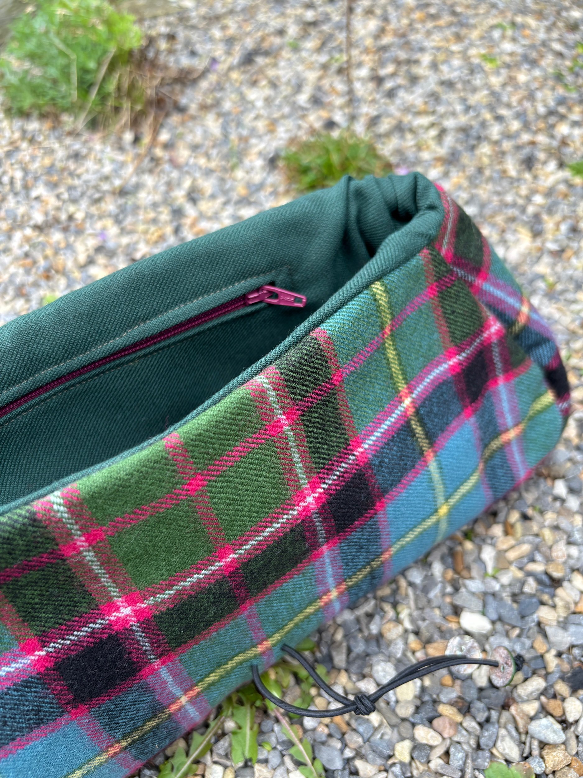 Rich green lining with pink zipped pocket inside handmade Scottish tartan Peerie Poak clutch bag by Julia Cunningham